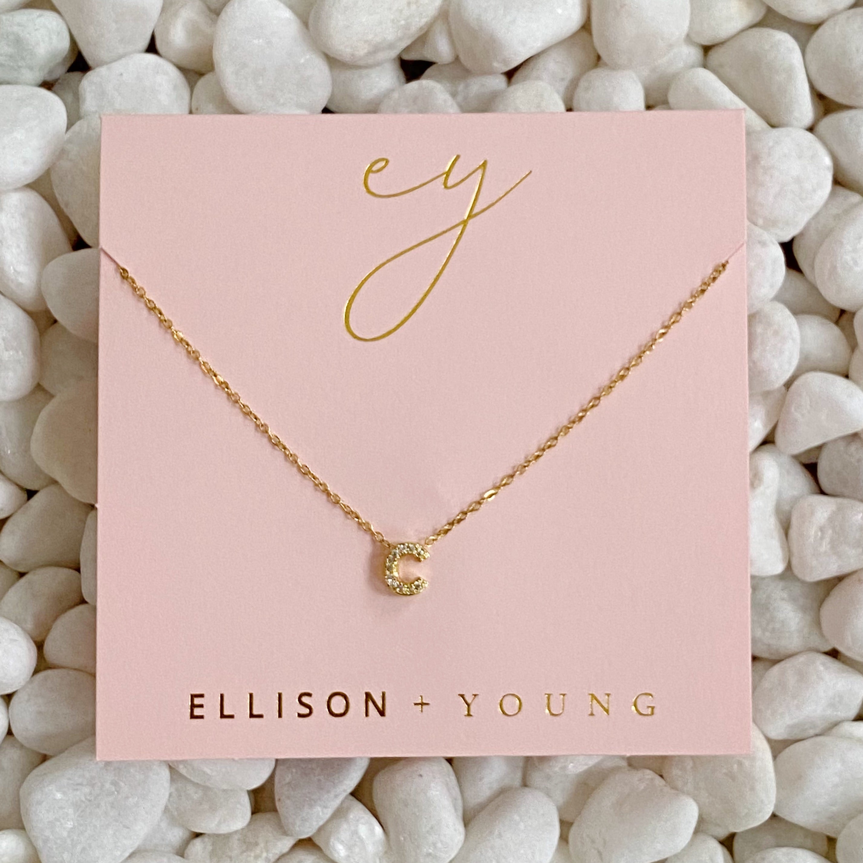 Mini Keepsake Initial Necklace featuring a small initial pendant on a dainty gold plated chain with cubic zirconia accents.