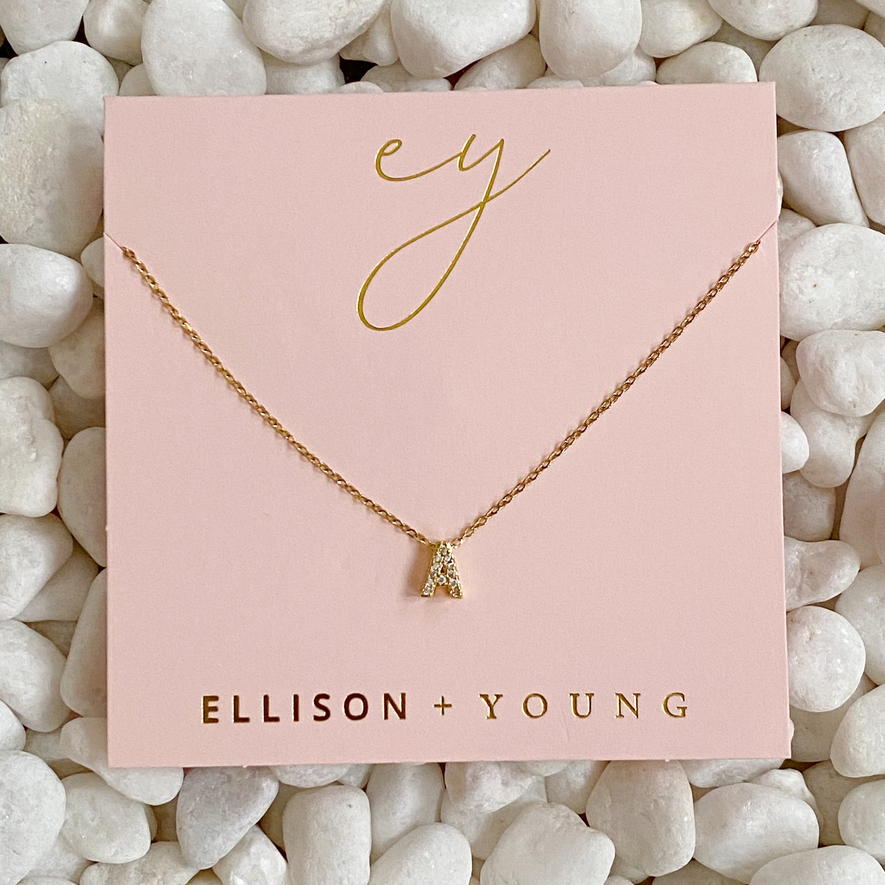 Mini Keepsake Initial Necklace featuring a small initial pendant on a dainty gold plated chain with cubic zirconia accents.