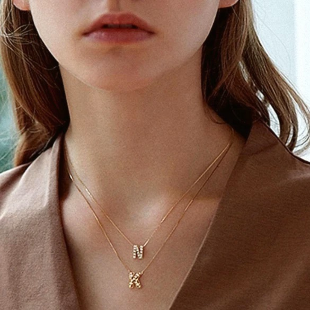 Mini Keepsake Initial Necklace featuring a small initial pendant on a dainty gold plated chain with cubic zirconia accents.