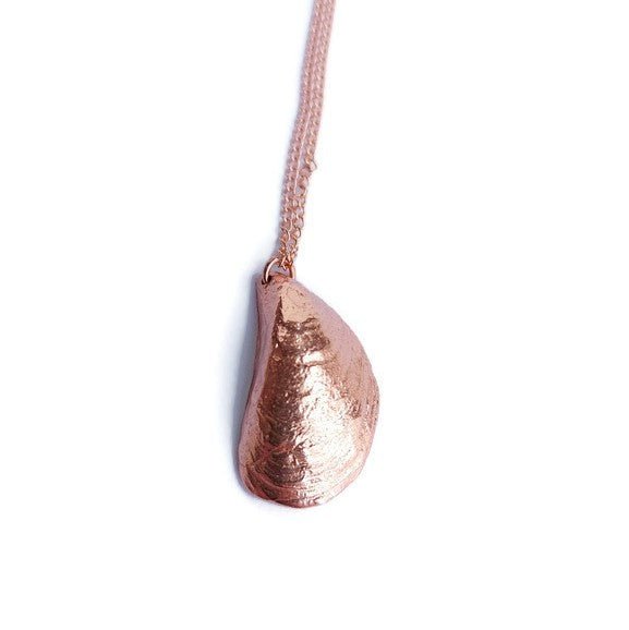 A delicate Mini Moanna Mussel Shell Necklace made of sterling silver, showcasing intricate details and a petite design.