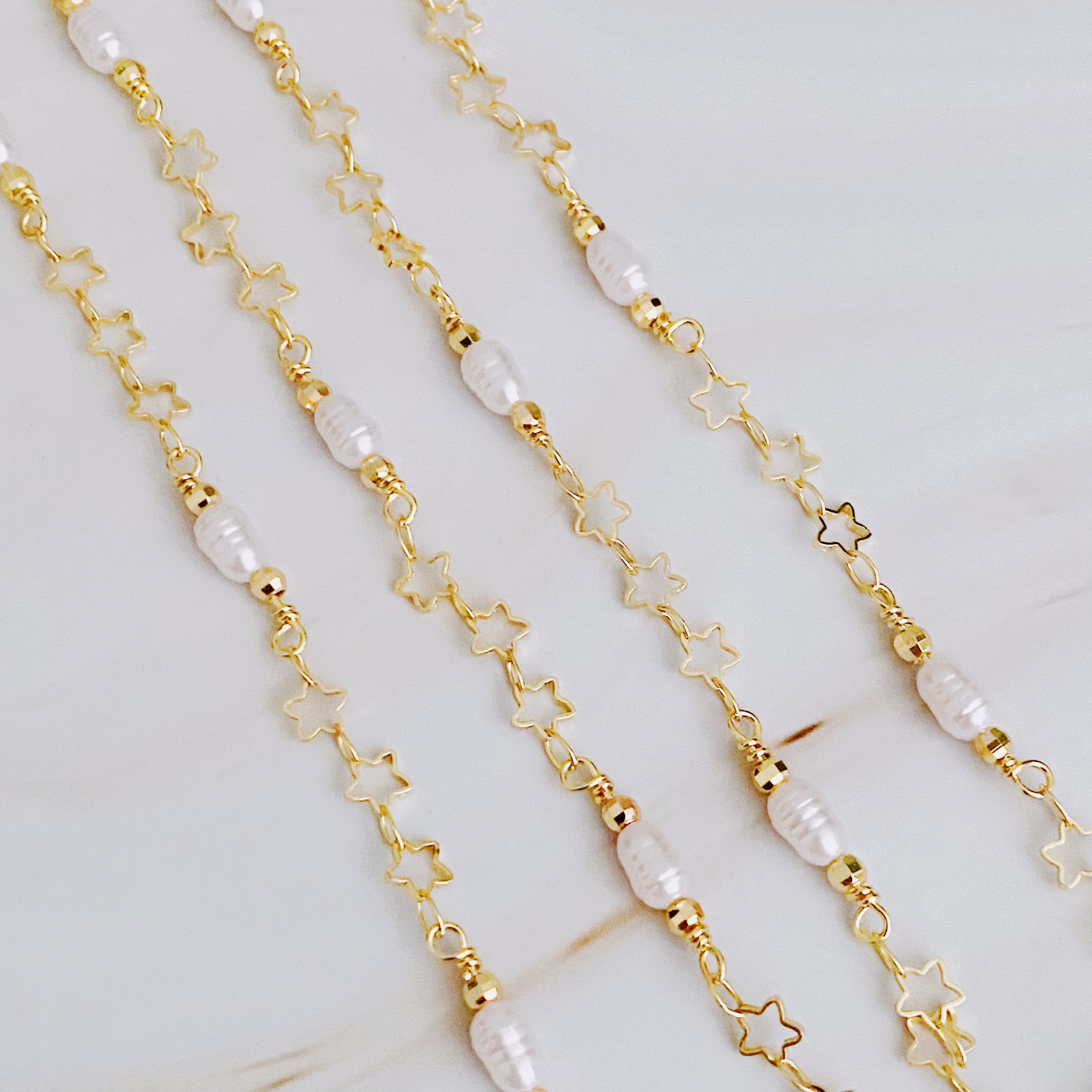 Mini Pearl Mini Star Long Chain Necklace featuring delicate stars and pearl beads, elegantly designed for versatile styling.