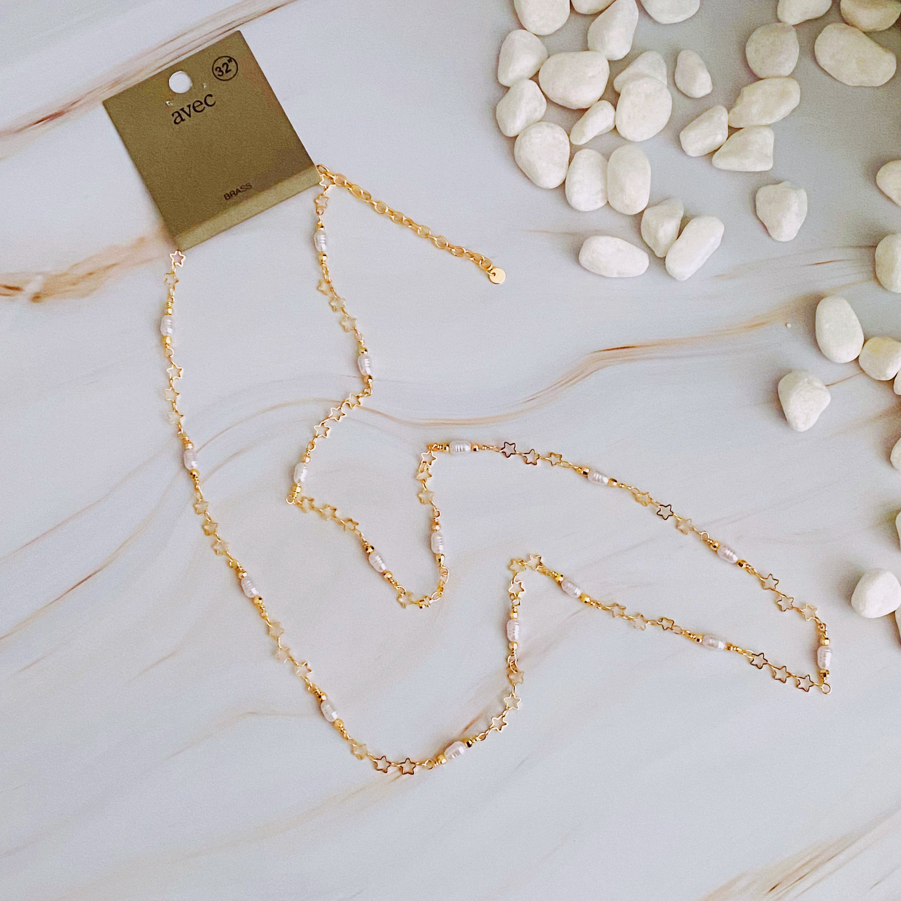 Mini Pearl Mini Star Long Chain Necklace featuring delicate stars and pearl beads, elegantly designed for versatile styling.