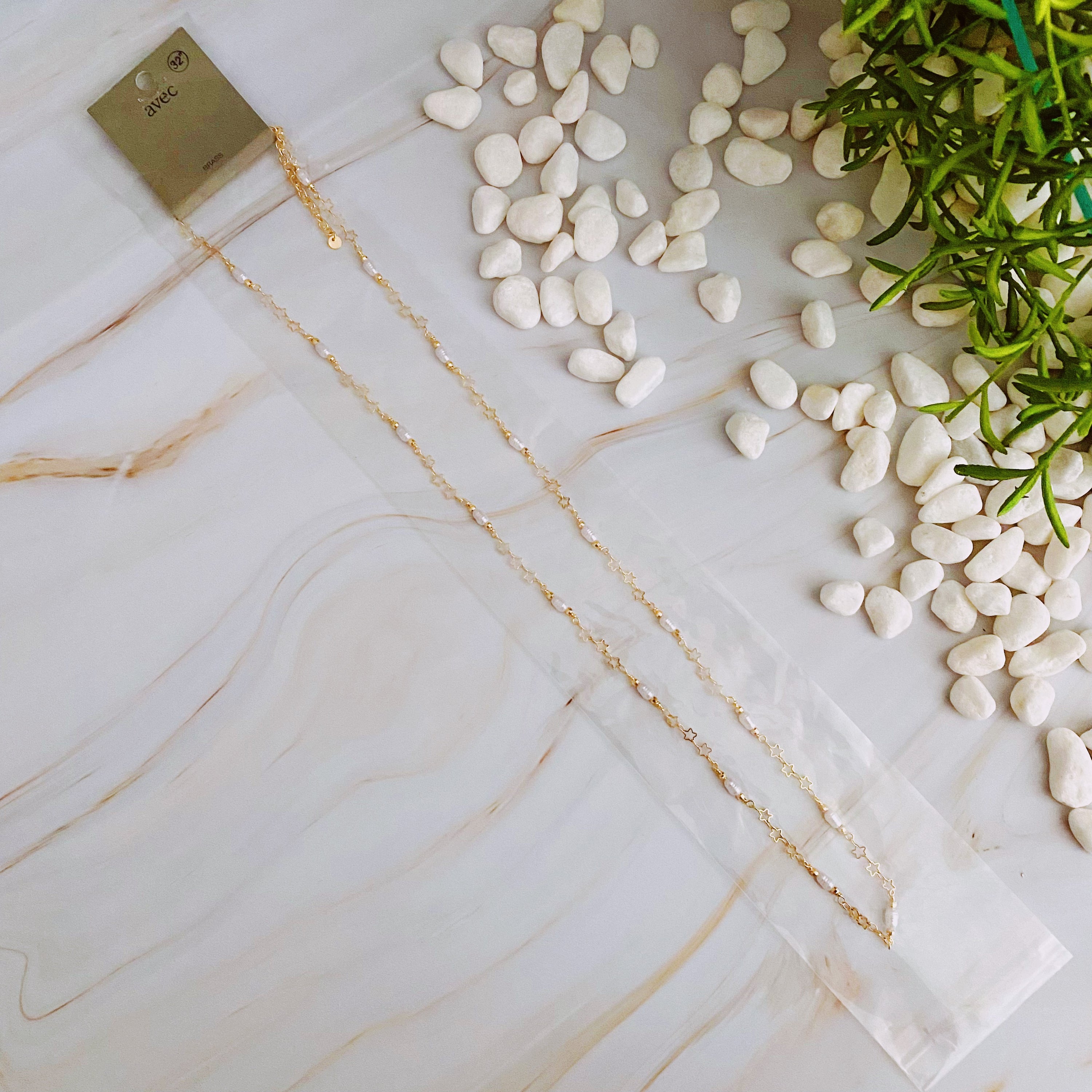 Mini Pearl Mini Star Long Chain Necklace featuring delicate stars and pearl beads, elegantly designed for versatile styling.