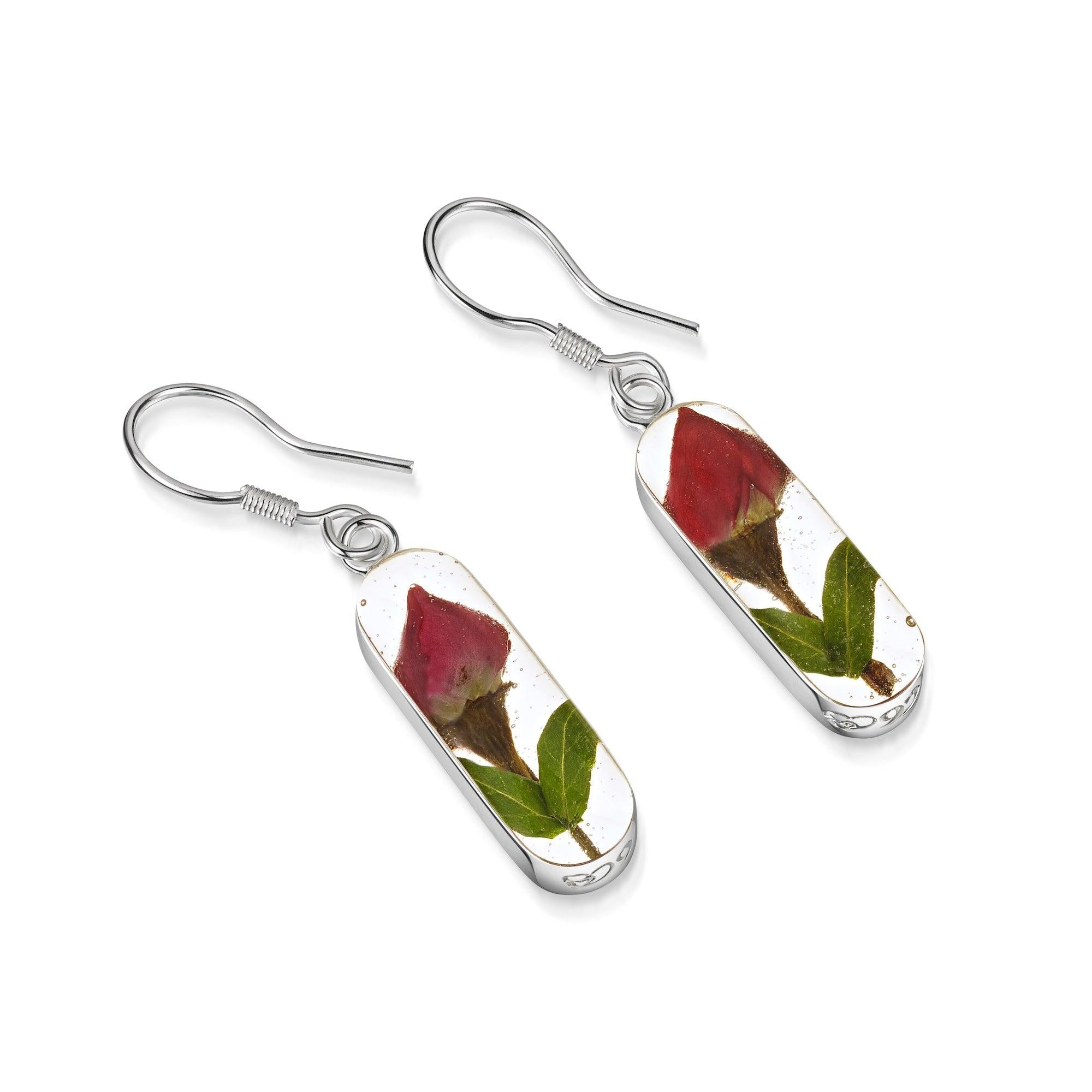 Elegant sterling silver drop earrings featuring real miniature rose buds encased in resin, part of the Leela collection.