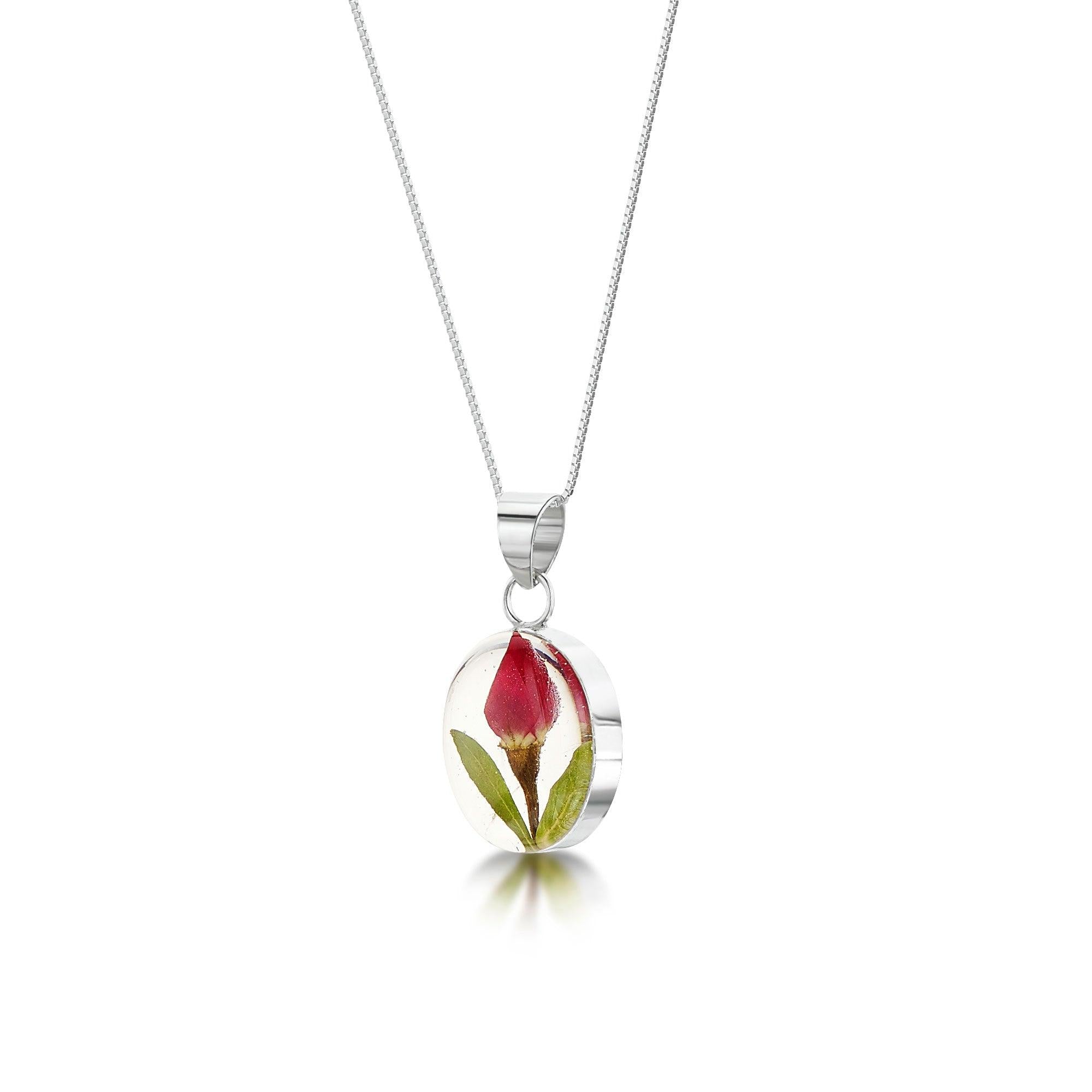 Miniature rose necklace featuring a sterling silver oval pendant with an adjustable chain, elegantly displayed in a gift box.