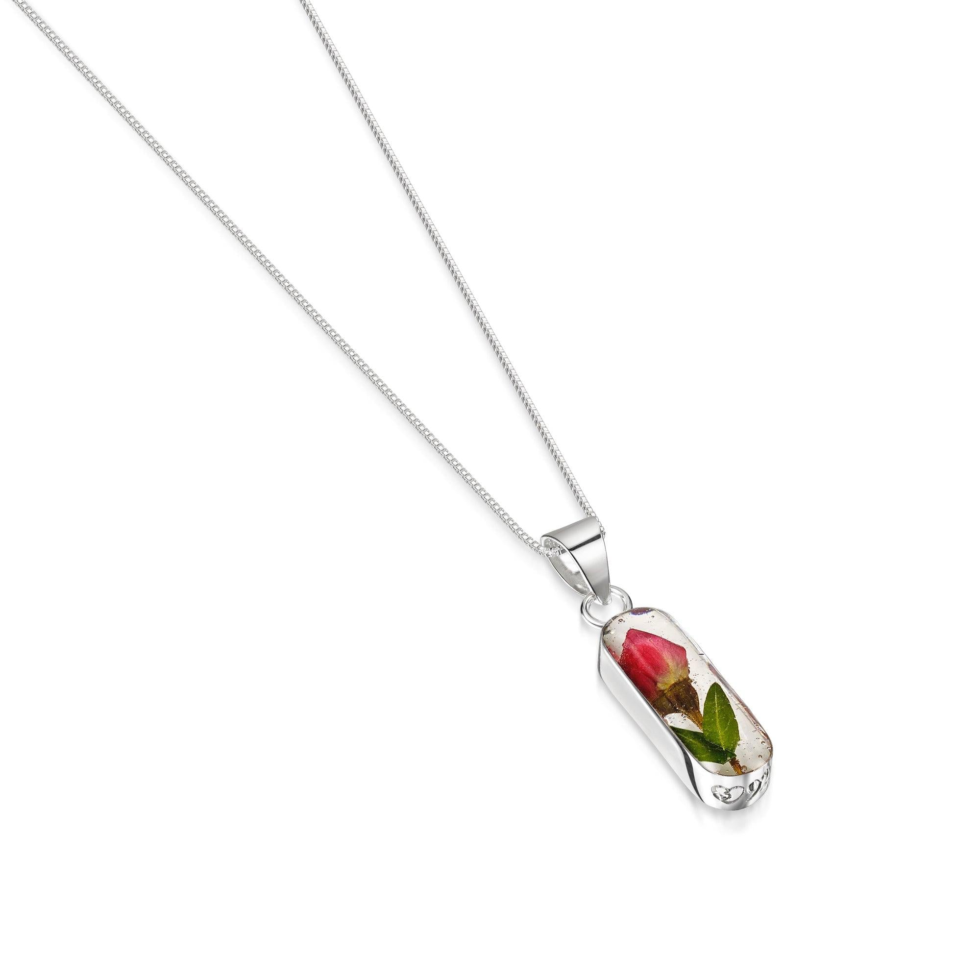 Miniature Rose necklace 'Leela' featuring a vertical bar pendant with a preserved rose bud, handmade in sterling silver.