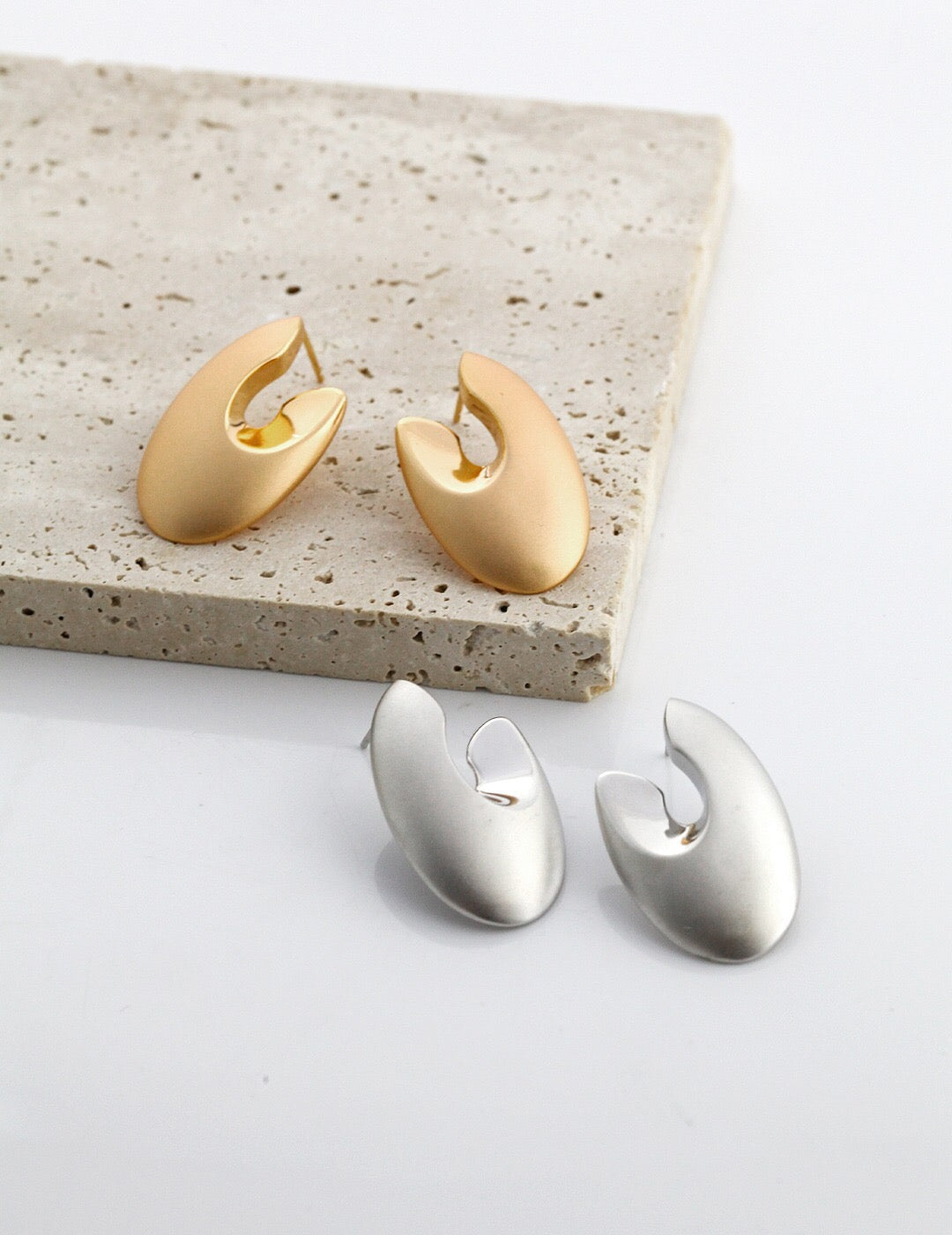 A pair of elegant Minimalist Abstract Earrings made from sterling silver and gold vermeil, showcasing a modern design.