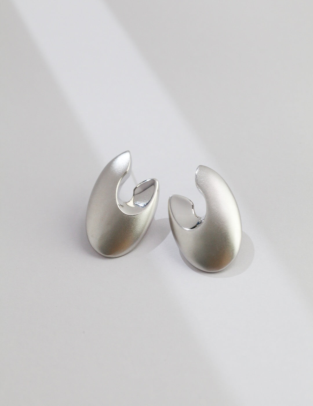 A pair of elegant Minimalist Abstract Earrings made from sterling silver and gold vermeil, showcasing a modern design.