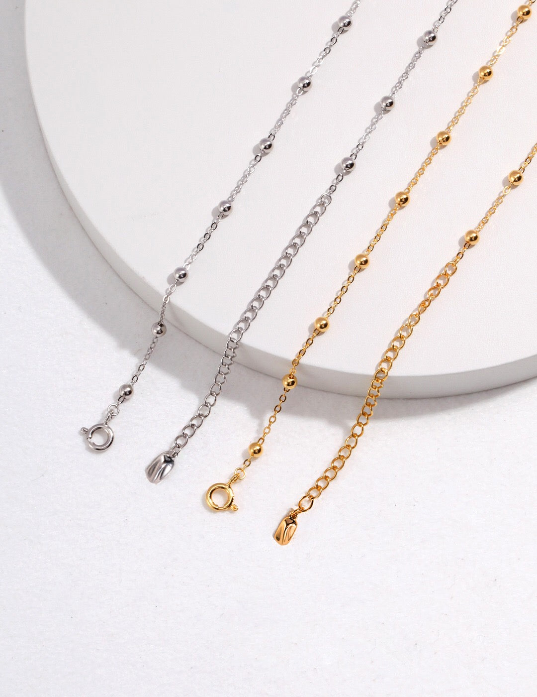 A delicate Minimalist Ball Chain Necklace featuring gold vermeil and silver beads, elegantly displayed on a soft background.