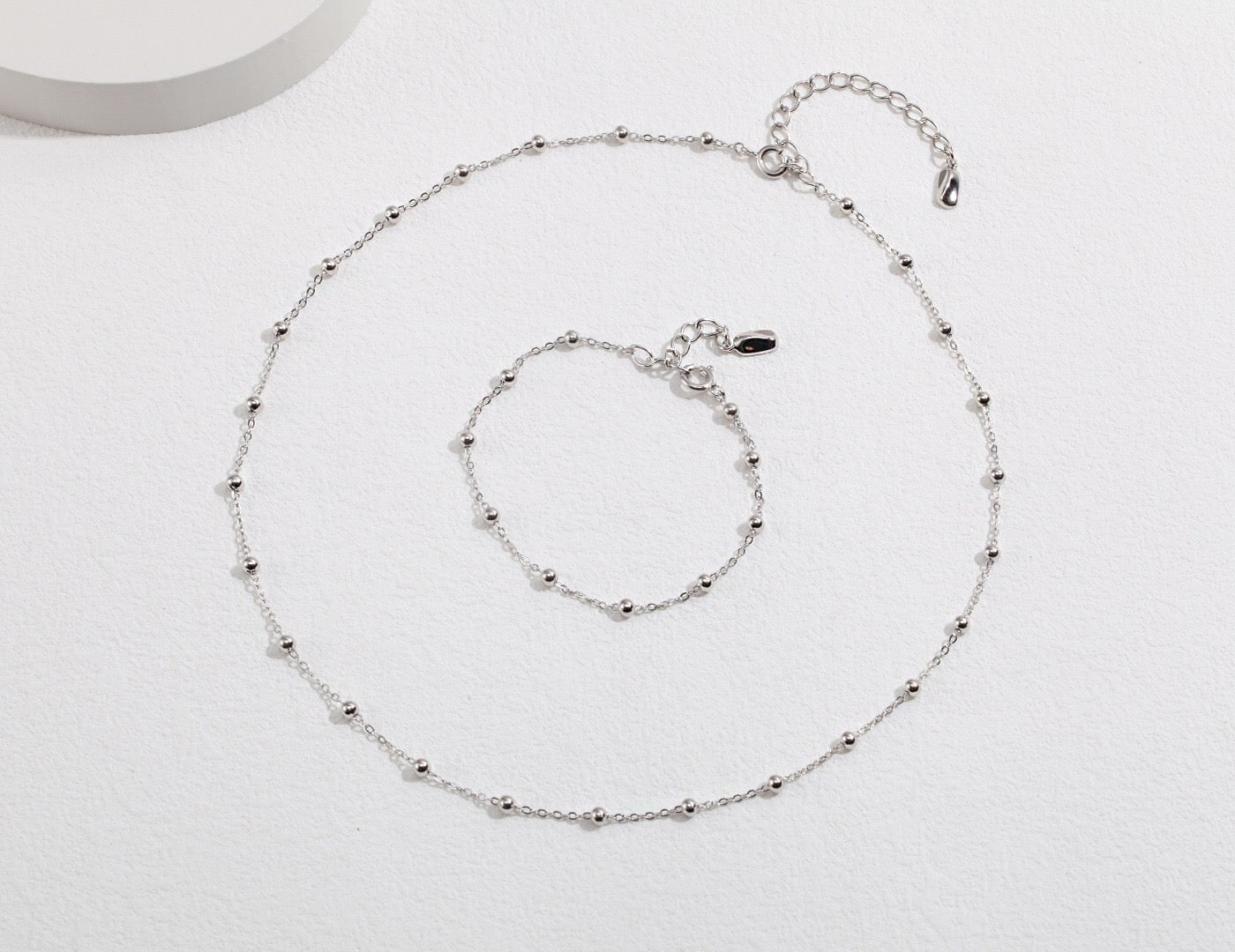 A delicate Minimalist Ball Chain Necklace featuring gold vermeil and silver beads, elegantly displayed on a soft background.