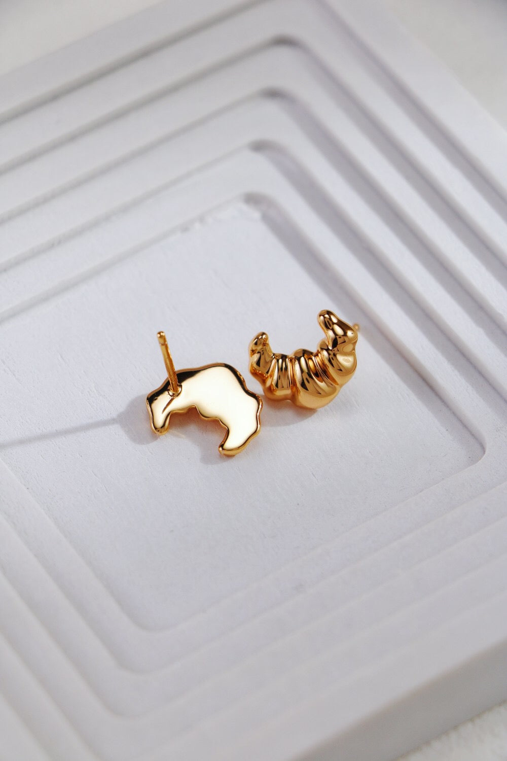 Minimalist Croissant Stud Earrings made of sterling silver and gold vermeil, showcasing a delicate croissant shape.