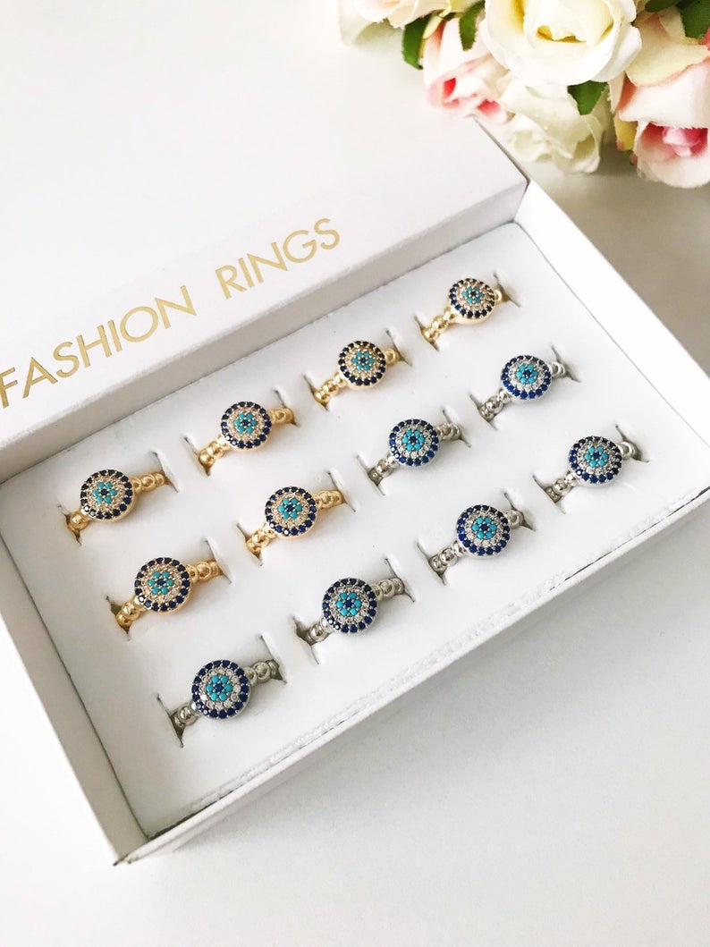 A stylish Minimalist Evil Eye Ring featuring a blue evil eye design with cubic zirconia accents, adjustable for all sizes, available in gold and silver.