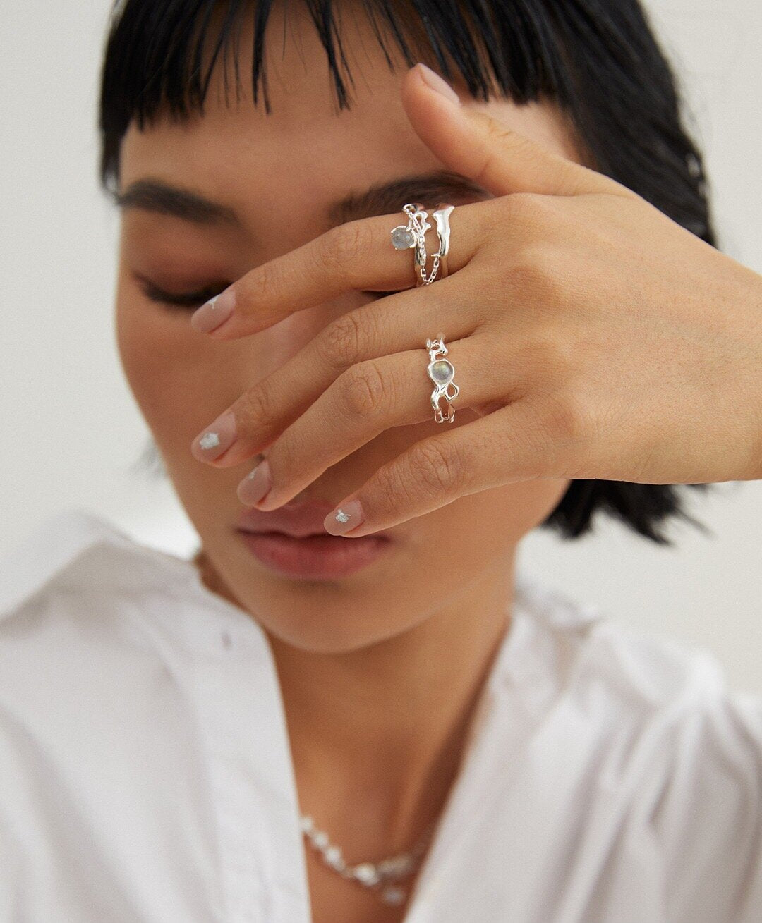 A handcrafted minimalist grey moonstone ring made of sterling silver, featuring a 5mm grey moonstone set in a sleek design.