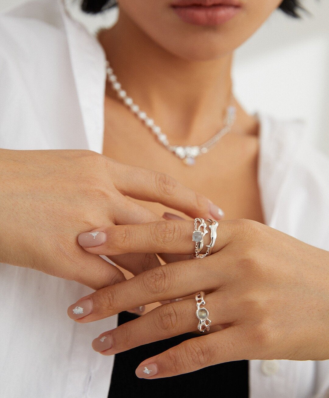 A handcrafted minimalist grey moonstone ring made of sterling silver, featuring a 5mm grey moonstone set in a sleek design.