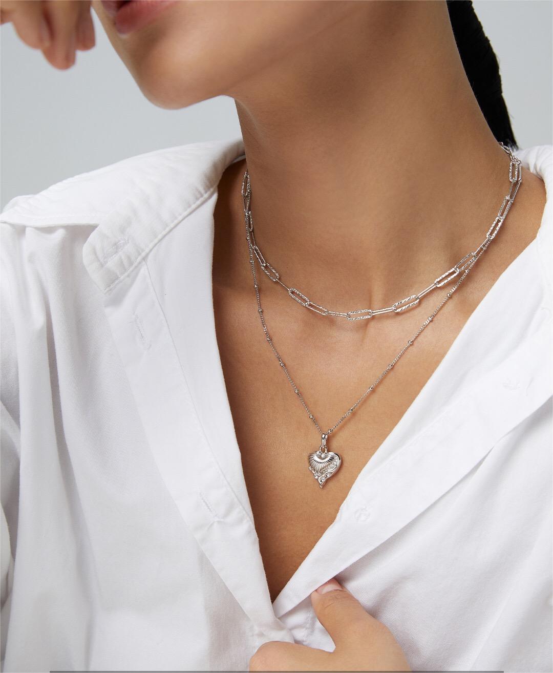 A delicate Minimalist Love Heart Necklace featuring natural stones and gold vermeil, elegantly displayed on a soft background.