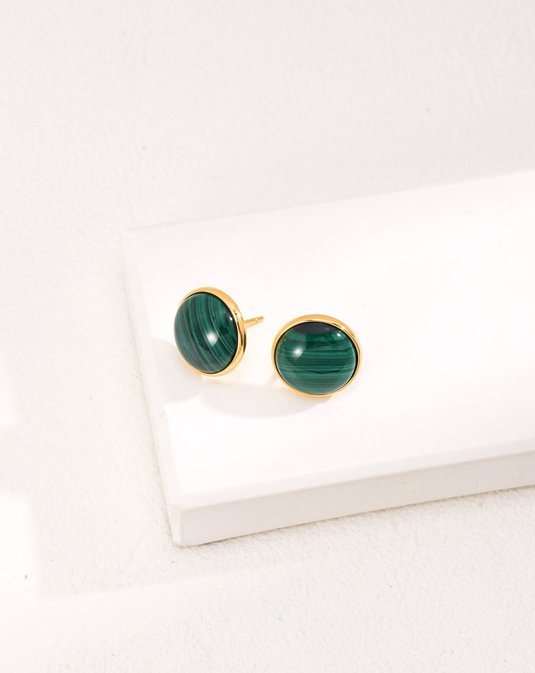 A pair of Minimalist Malachite Stud Earrings featuring vibrant green malachite stones set in vintage gold 925 silver.