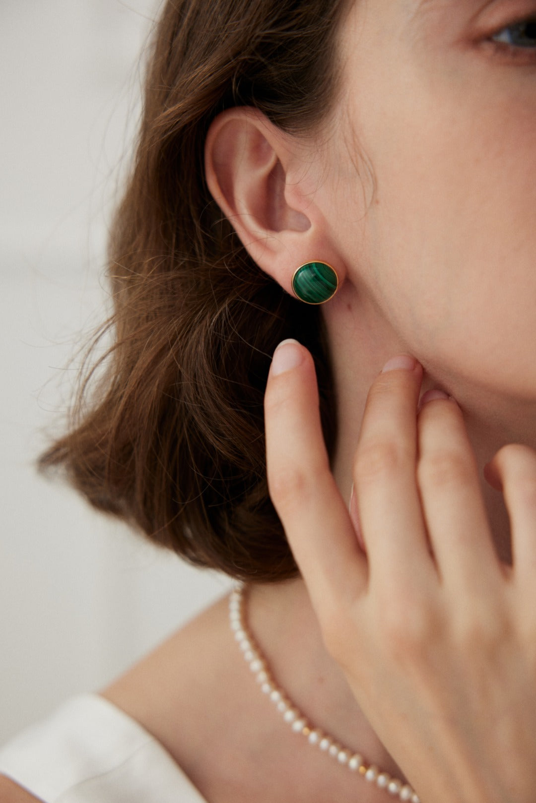 A pair of Minimalist Malachite Stud Earrings featuring vibrant green malachite stones set in vintage gold 925 silver.