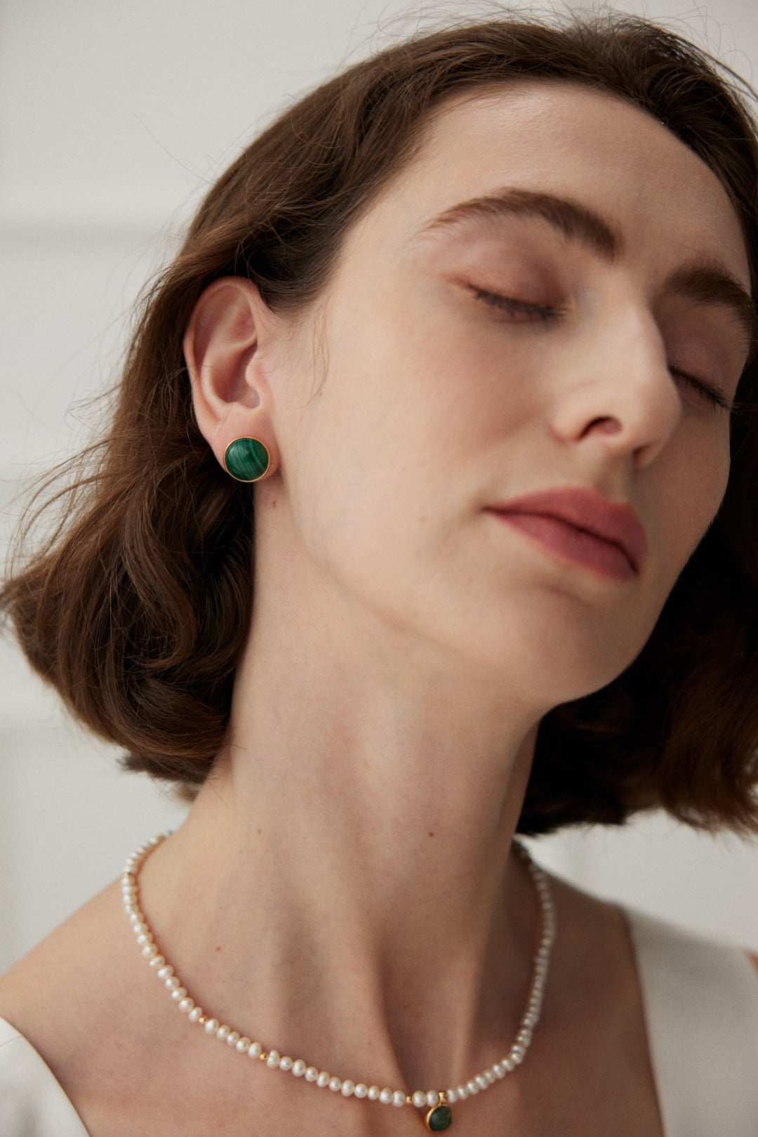 A pair of Minimalist Malachite Stud Earrings featuring vibrant green malachite stones set in vintage gold 925 silver.