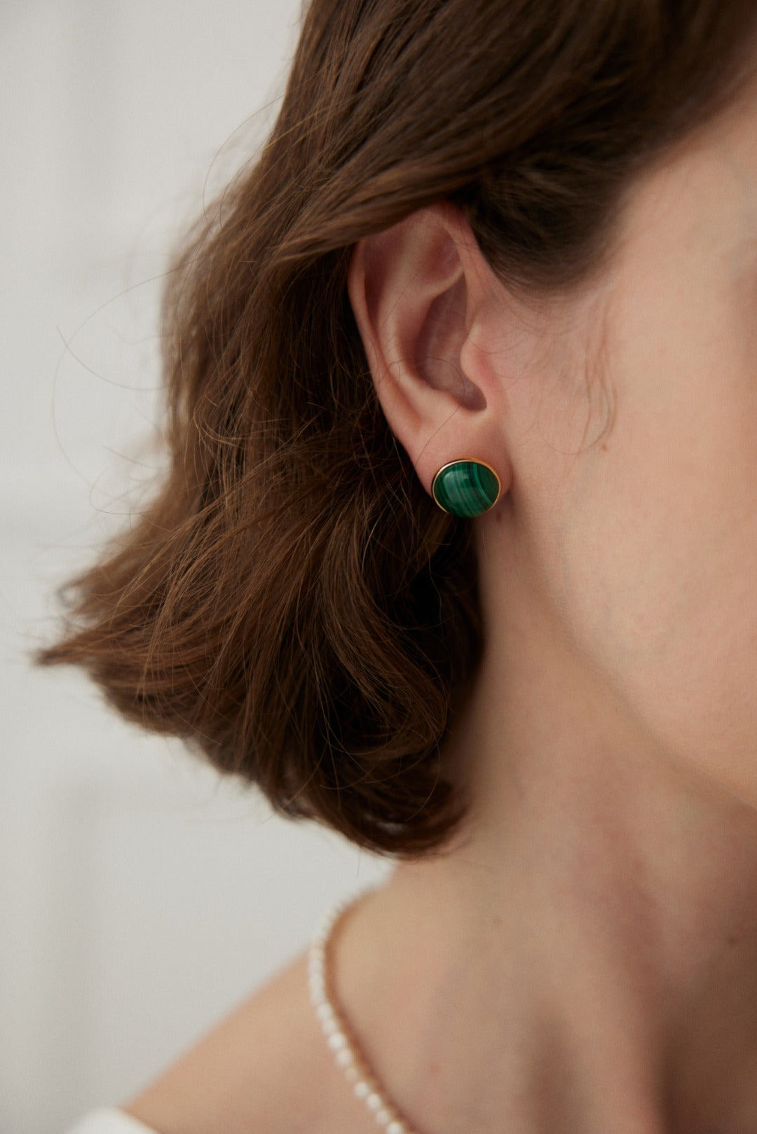 A pair of Minimalist Malachite Stud Earrings featuring vibrant green malachite stones set in vintage gold 925 silver.