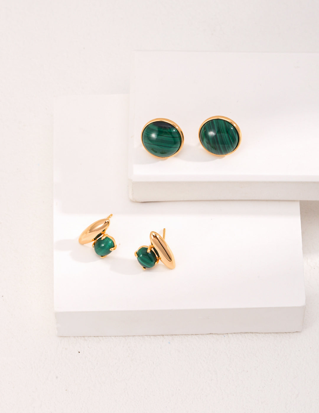 A pair of Minimalist Malachite Stud Earrings featuring vibrant green malachite stones set in vintage gold 925 silver.