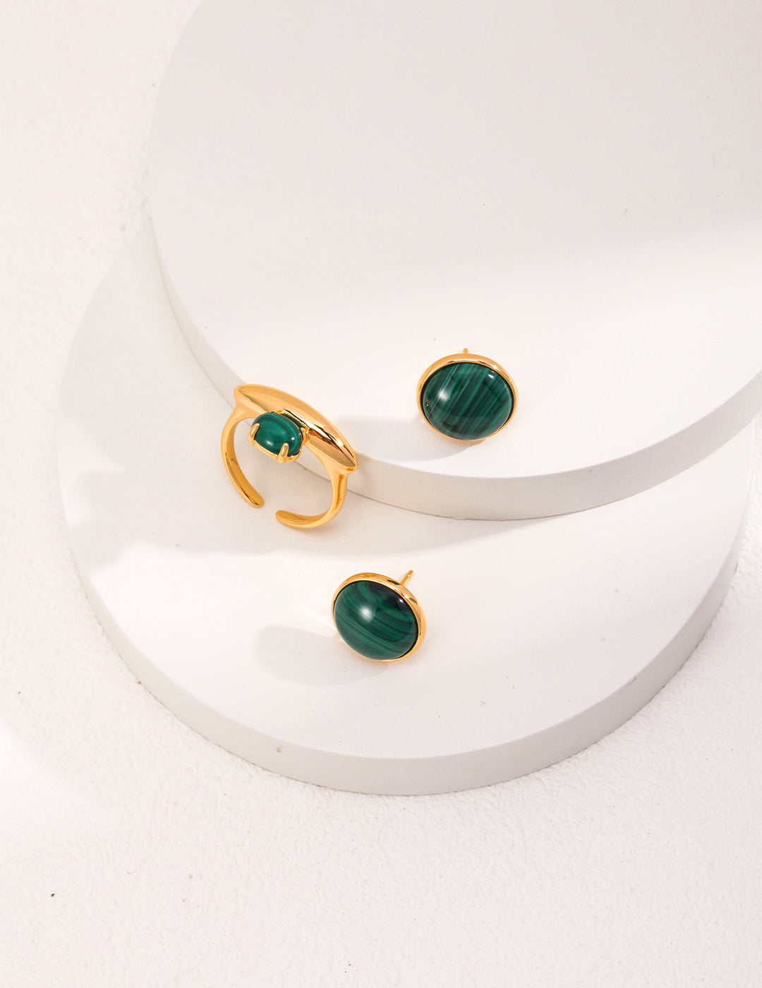 A pair of Minimalist Malachite Stud Earrings featuring vibrant green malachite stones set in vintage gold 925 silver.