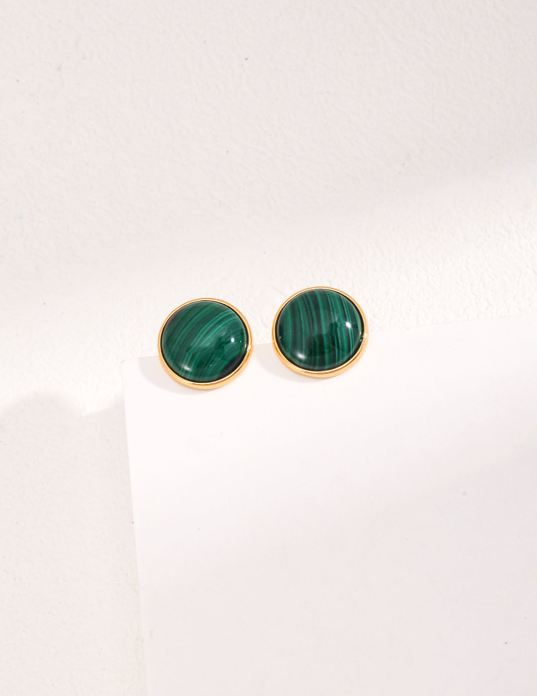 A pair of Minimalist Malachite Stud Earrings featuring vibrant green malachite stones set in vintage gold 925 silver.