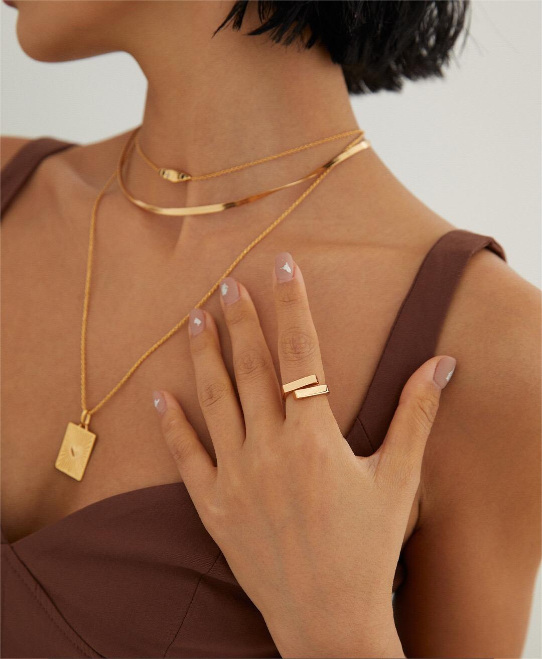 A close-up of a Minimalist Modern Stacking Ring made of gold vermeil, showcasing its sleek design and adjustable size.