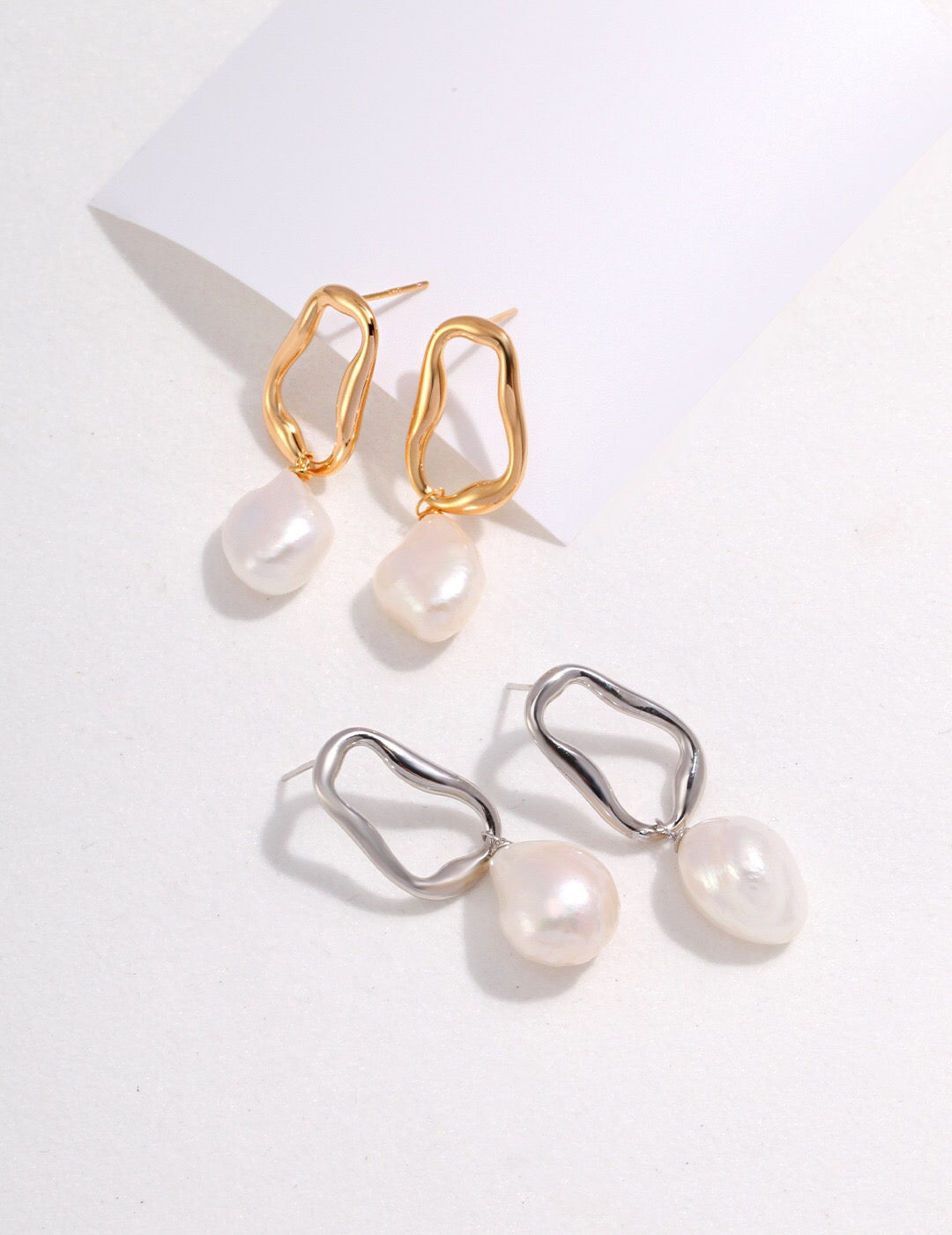 A pair of elegant Minimalist Pearl Dangle Earrings featuring freshwater pearls and gold vermeil, showcasing their delicate design and craftsmanship.