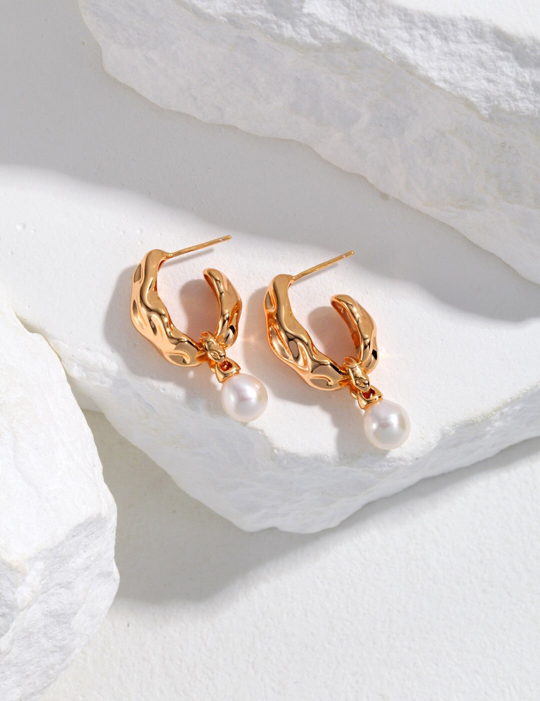 A pair of elegant Minimalist Pearl Hoop Earrings featuring freshwater pearls and a sterling silver base with gold vermeil plating.