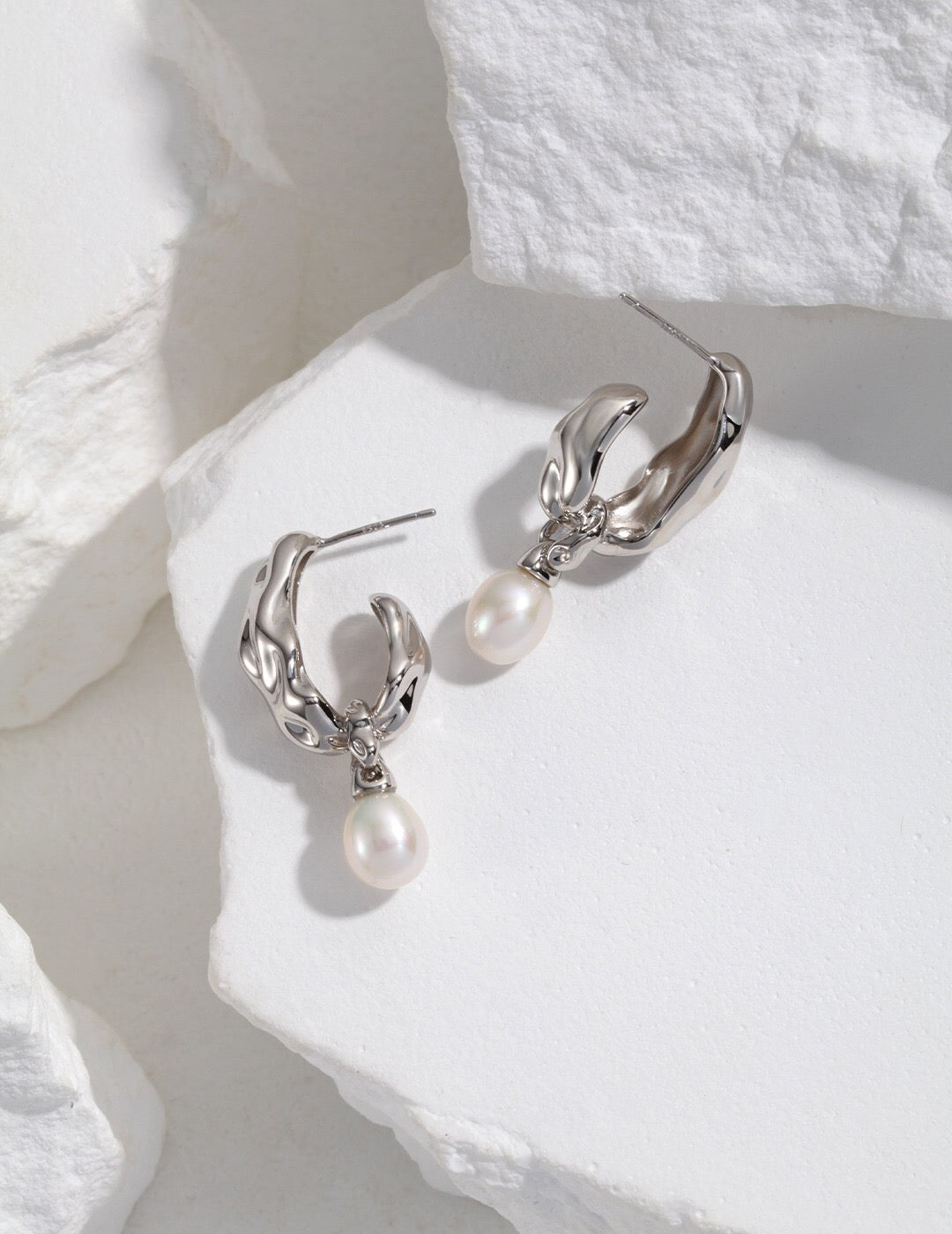 A pair of elegant Minimalist Pearl Hoop Earrings featuring freshwater pearls and a sterling silver base with gold vermeil plating.