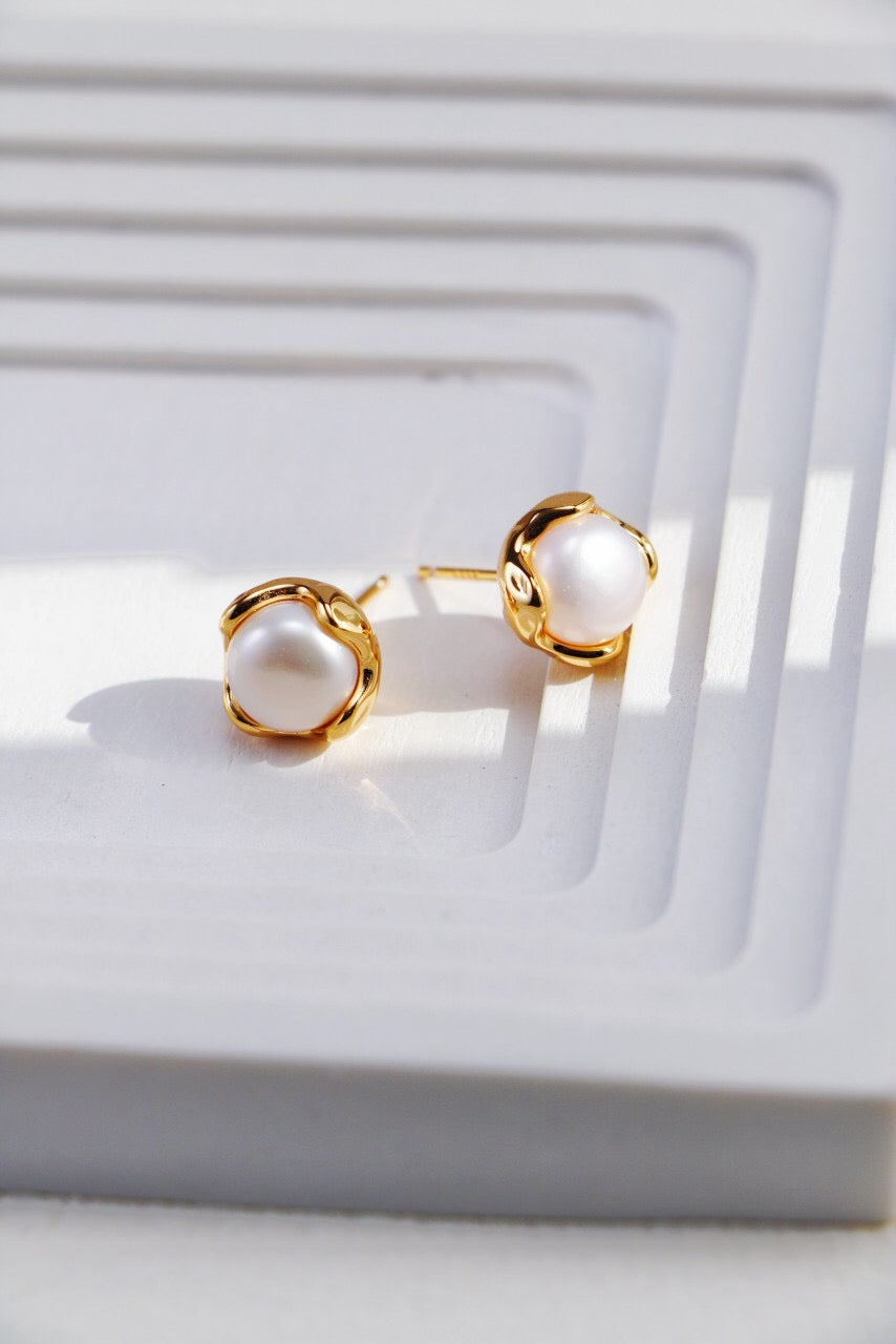 A pair of elegant Minimalist Pearl Stud Earrings featuring natural freshwater pearls set in sterling silver and gold vermeil.