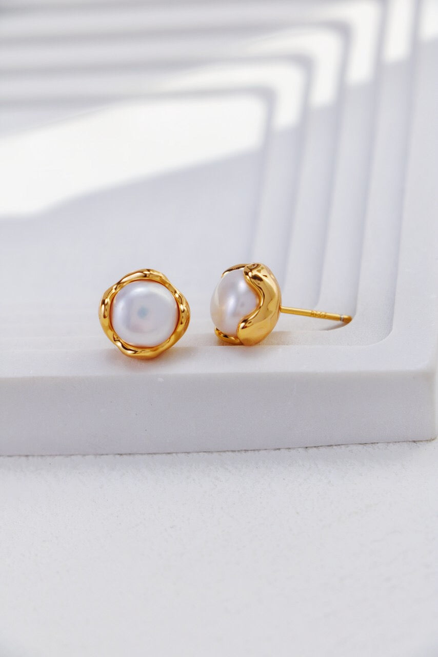 A pair of elegant Minimalist Pearl Stud Earrings featuring natural freshwater pearls set in sterling silver and gold vermeil.