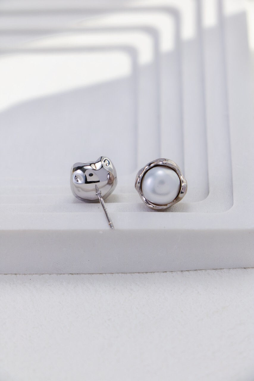 A pair of elegant Minimalist Pearl Stud Earrings featuring natural freshwater pearls set in sterling silver and gold vermeil.