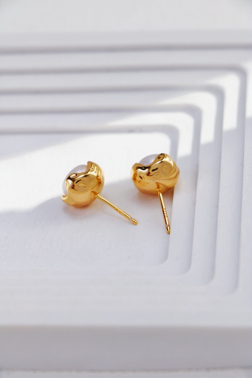 A pair of elegant Minimalist Pearl Stud Earrings featuring natural freshwater pearls set in sterling silver and gold vermeil.