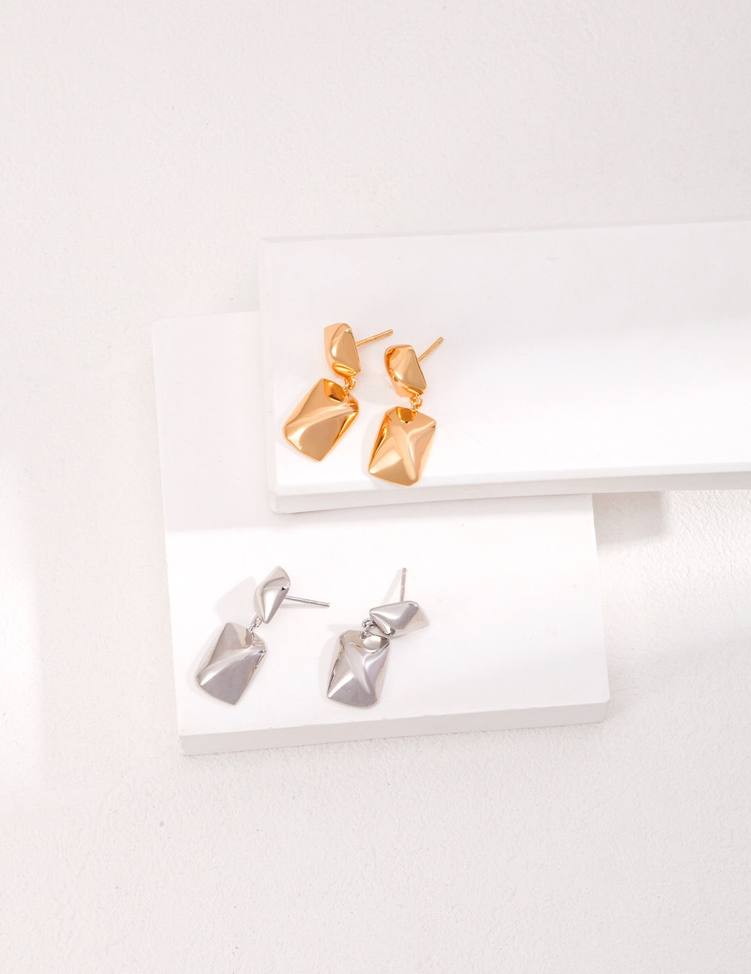 Minimalist rectangular shape earrings made of gold vermeil, showcasing their elegant design and craftsmanship.