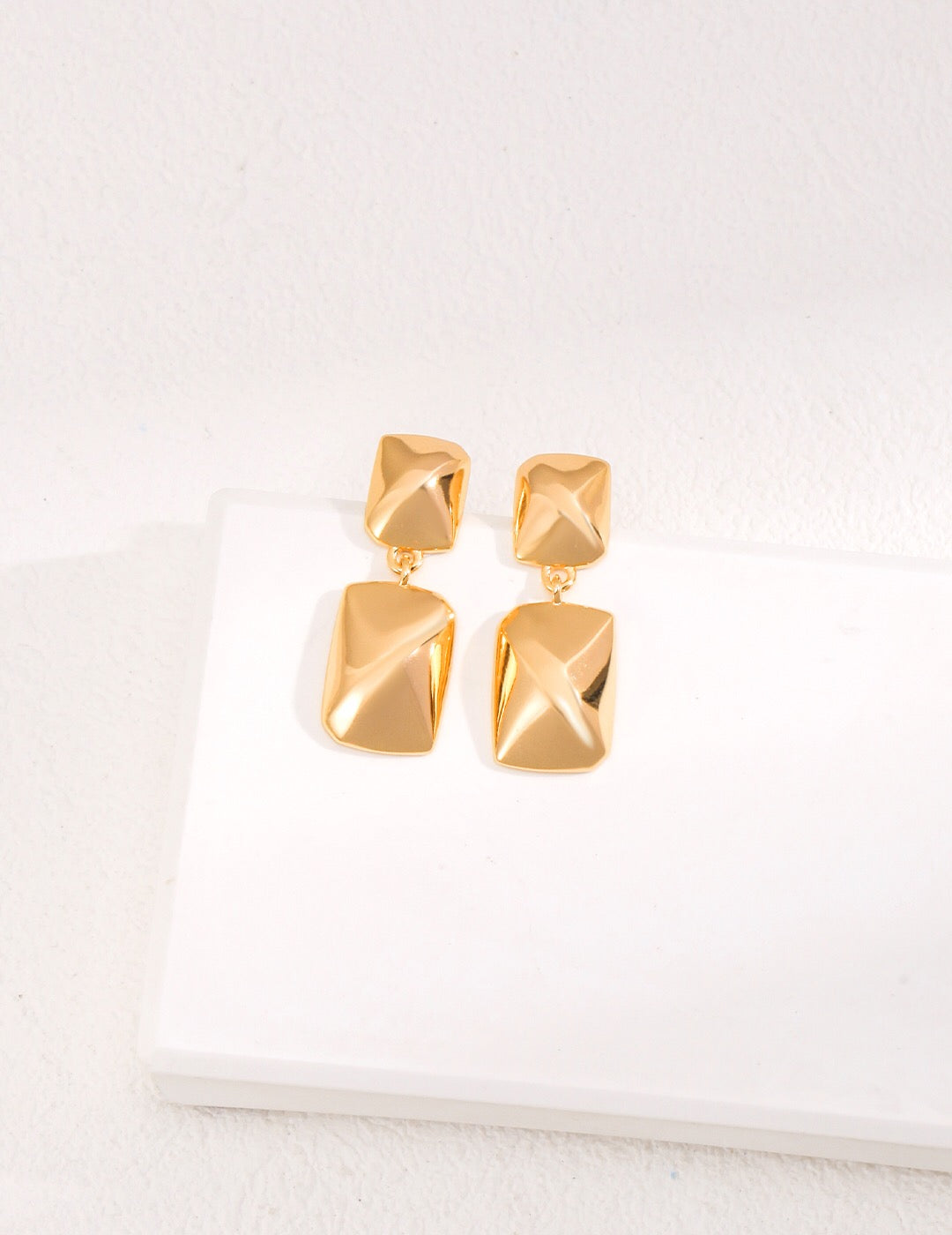 Minimalist rectangular shape earrings made of gold vermeil, showcasing their elegant design and craftsmanship.