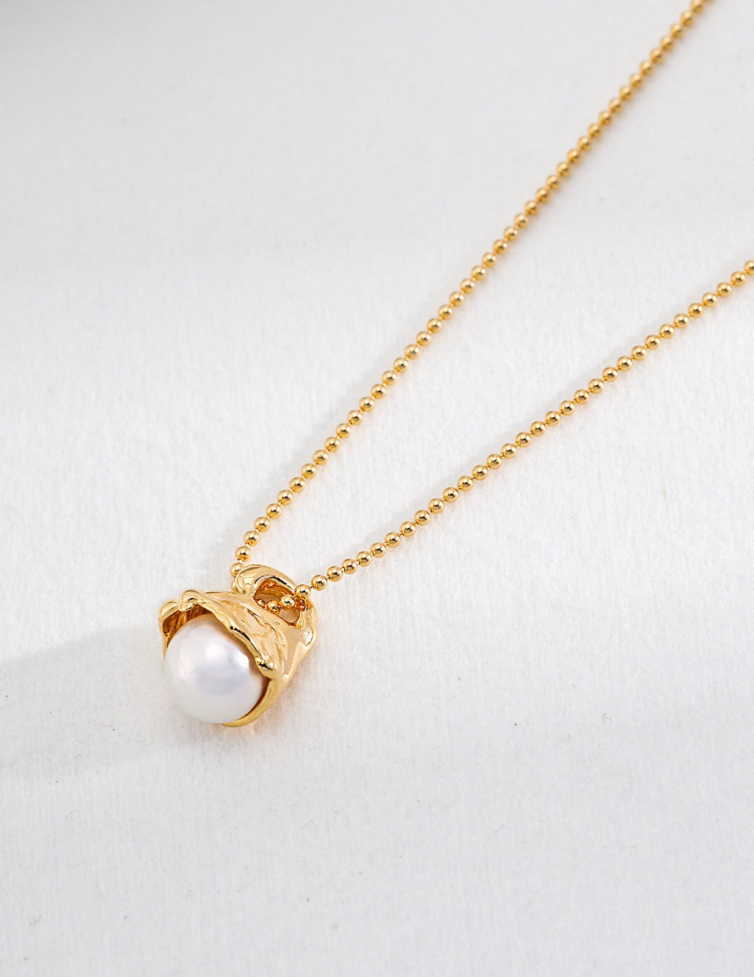 Minimalist Round Pearl Pendant Necklace featuring a natural pearl and gold vermeil chain, elegantly designed for versatile wear.