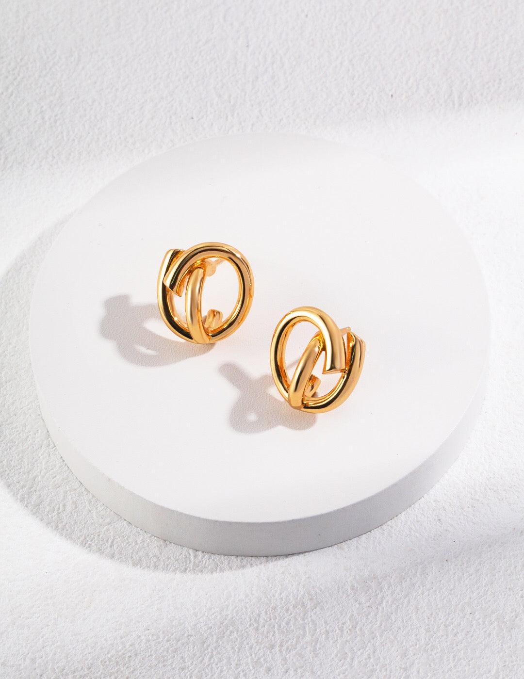 A pair of elegant Minimalist Style Stud Earrings made of gold vermeil, showcasing a simple yet chic design.