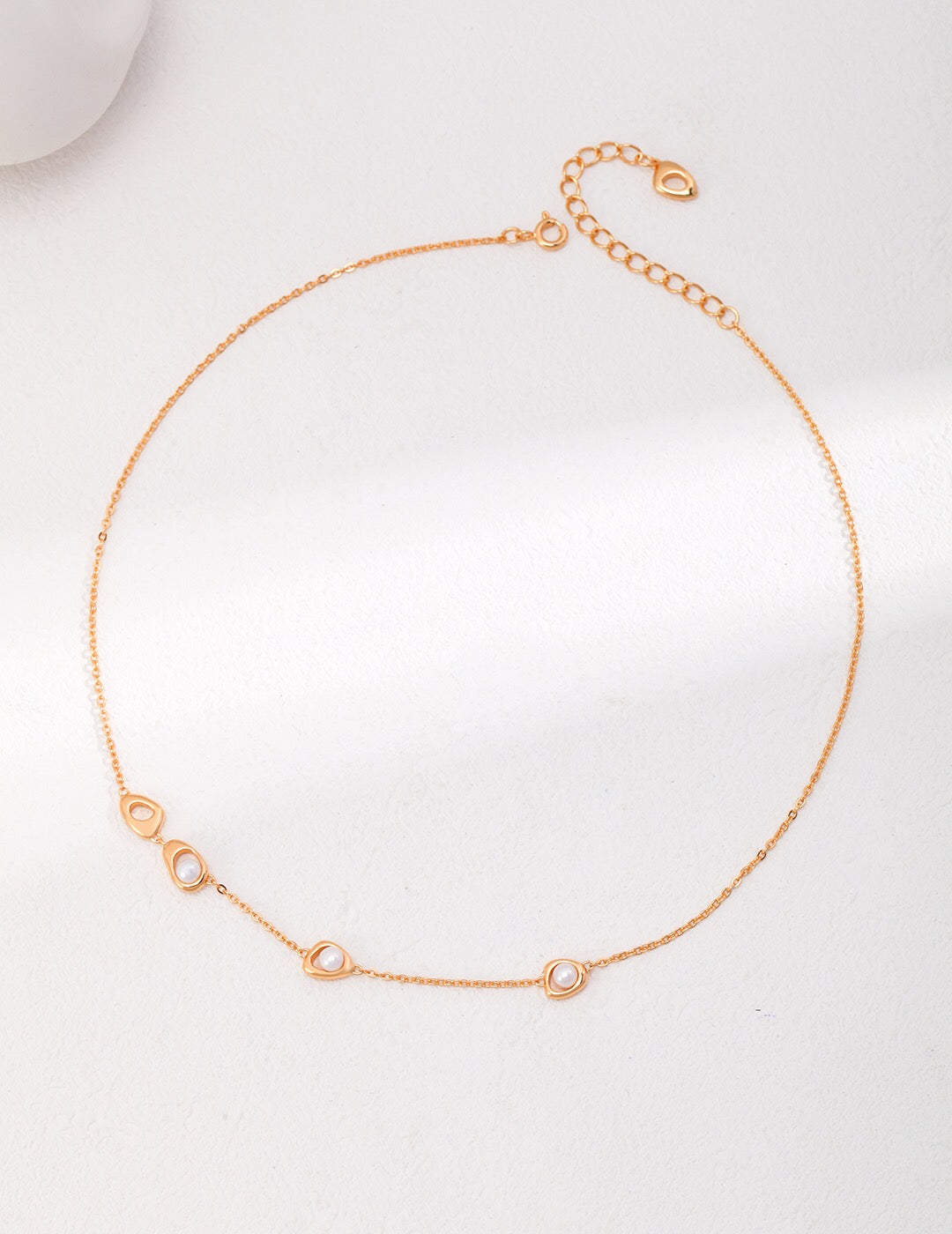 A delicate Minimalist Three Pearl Beads Necklace featuring three natural pearls on a gold vermeil chain, elegantly displayed on a soft background.