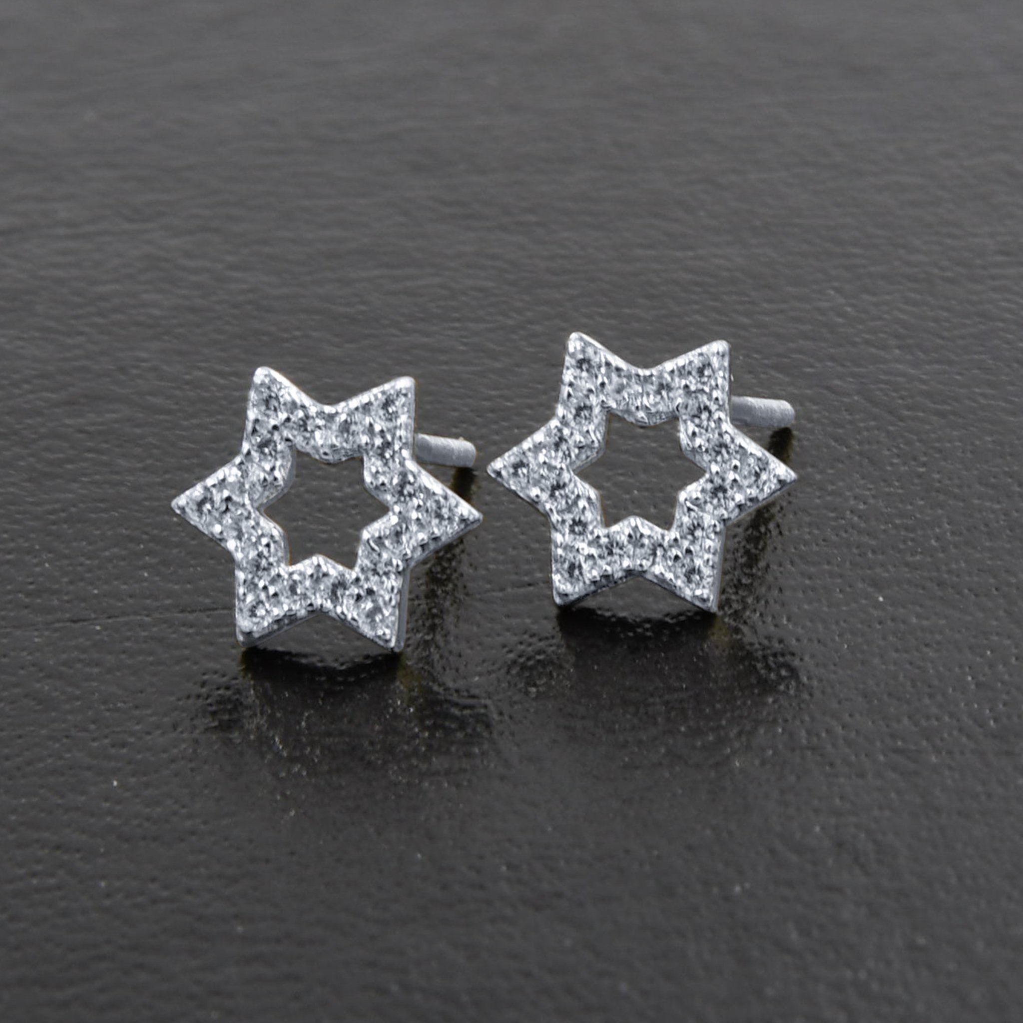 A pair of Miraculous Star Earrings made from 925 sterling silver, featuring sparkling cubic zircon stones in a unique star design.