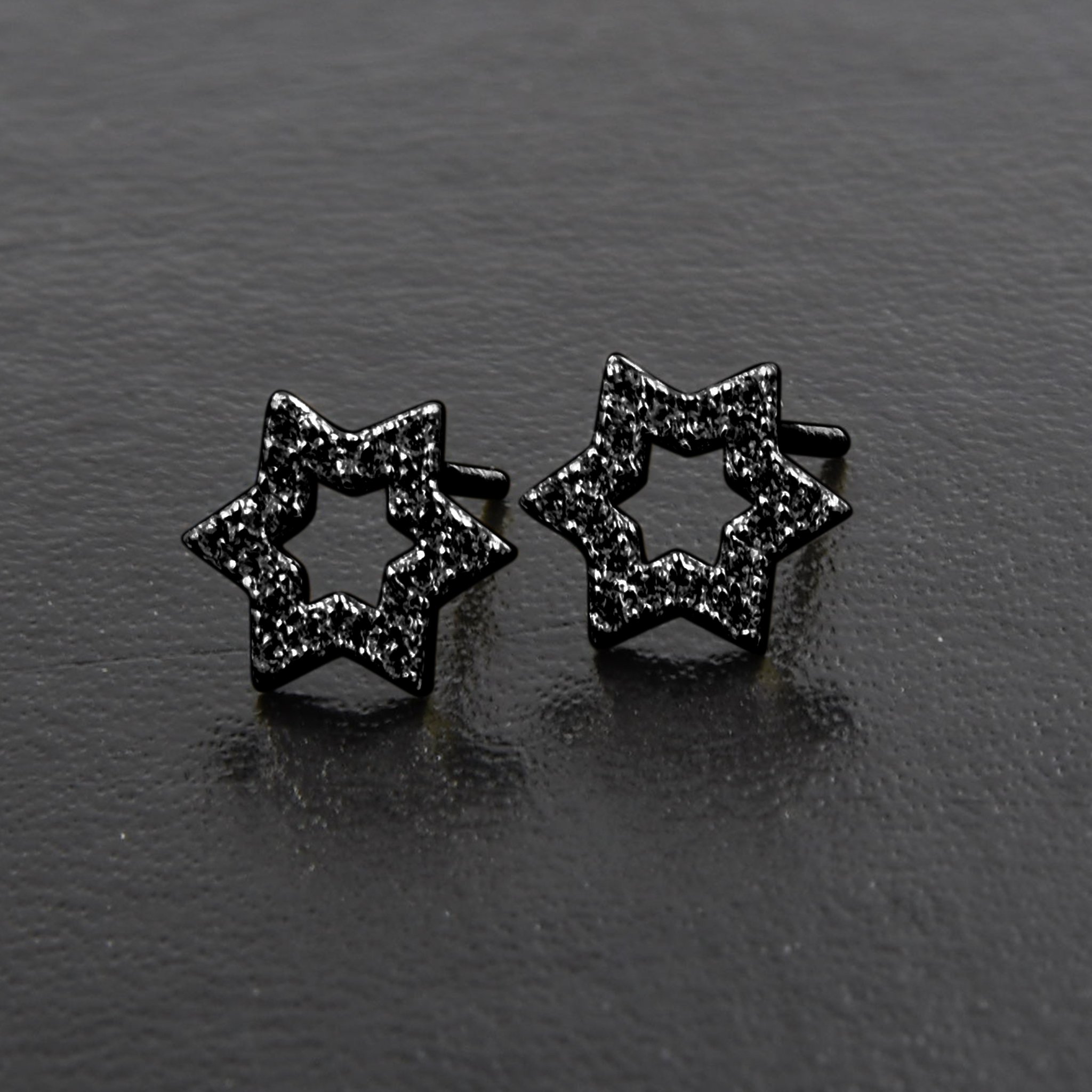 A pair of Miraculous Star Earrings made from 925 sterling silver, featuring sparkling cubic zircon stones in a unique star design.