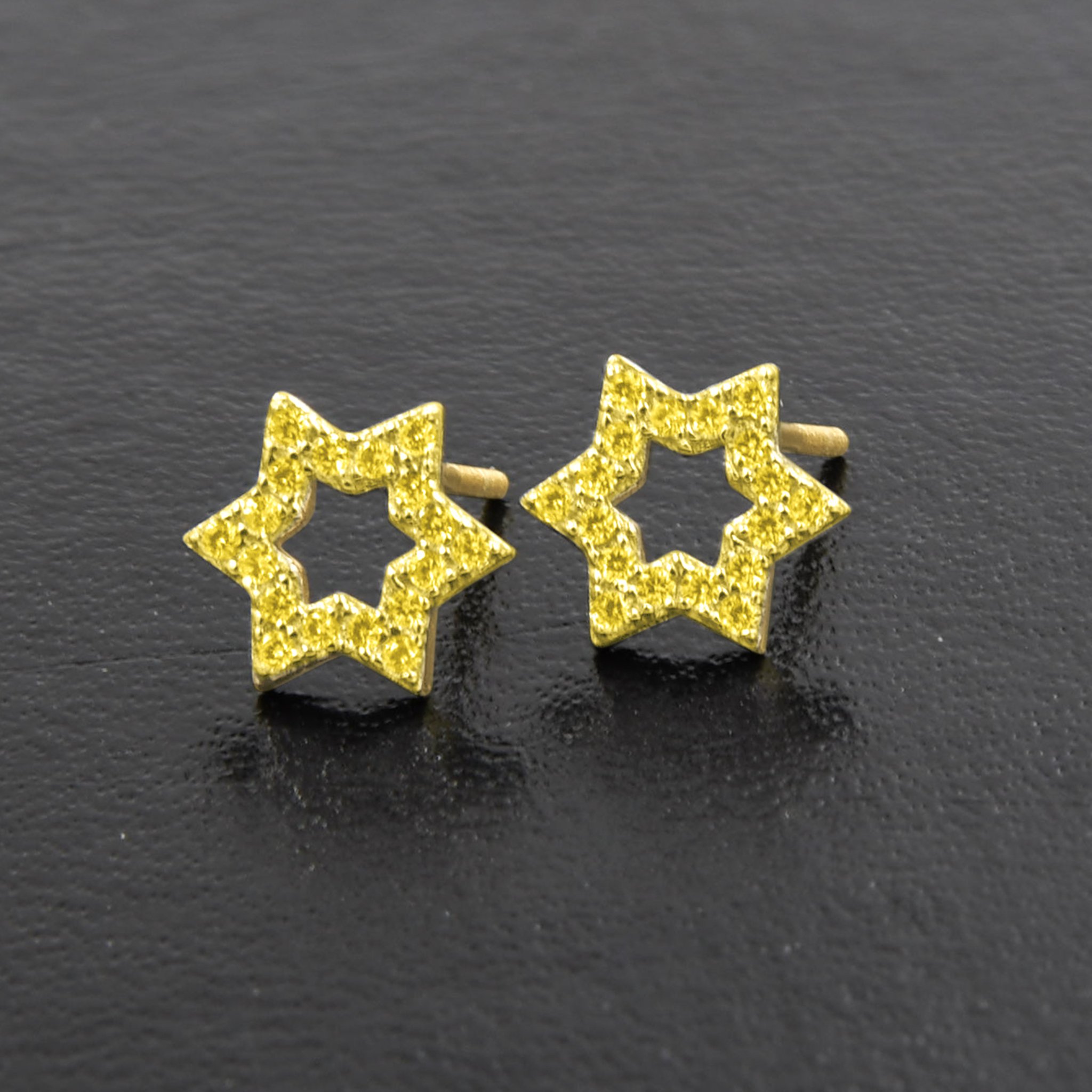 A pair of Miraculous Star Earrings made from 925 sterling silver, featuring sparkling cubic zircon stones in a unique star design.