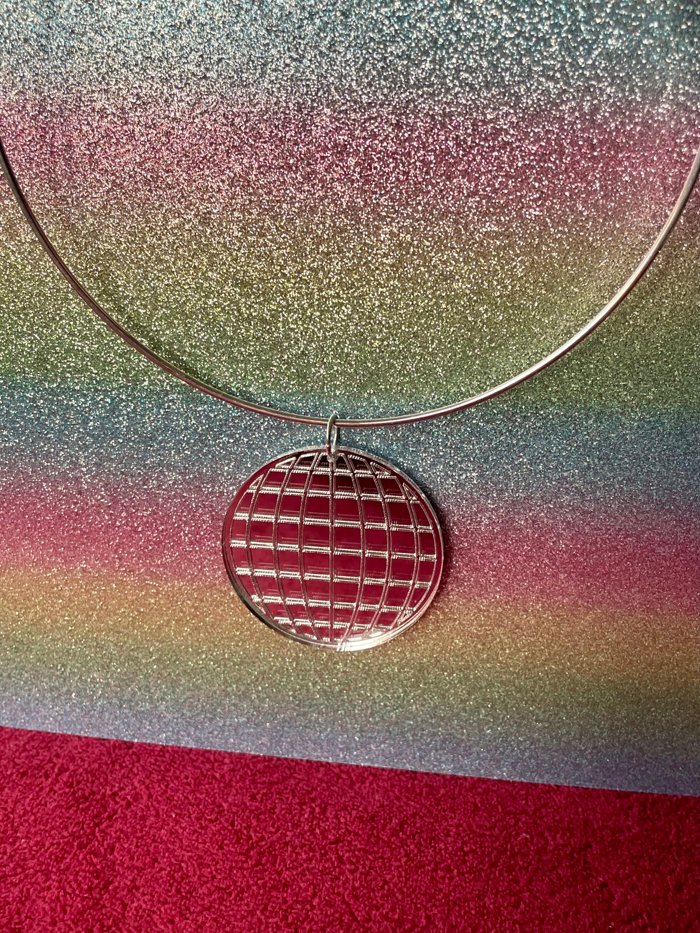 A stylish Mirror Ball Choker featuring a shiny mirror ball pendant, customizable colors, and a retro-inspired design.