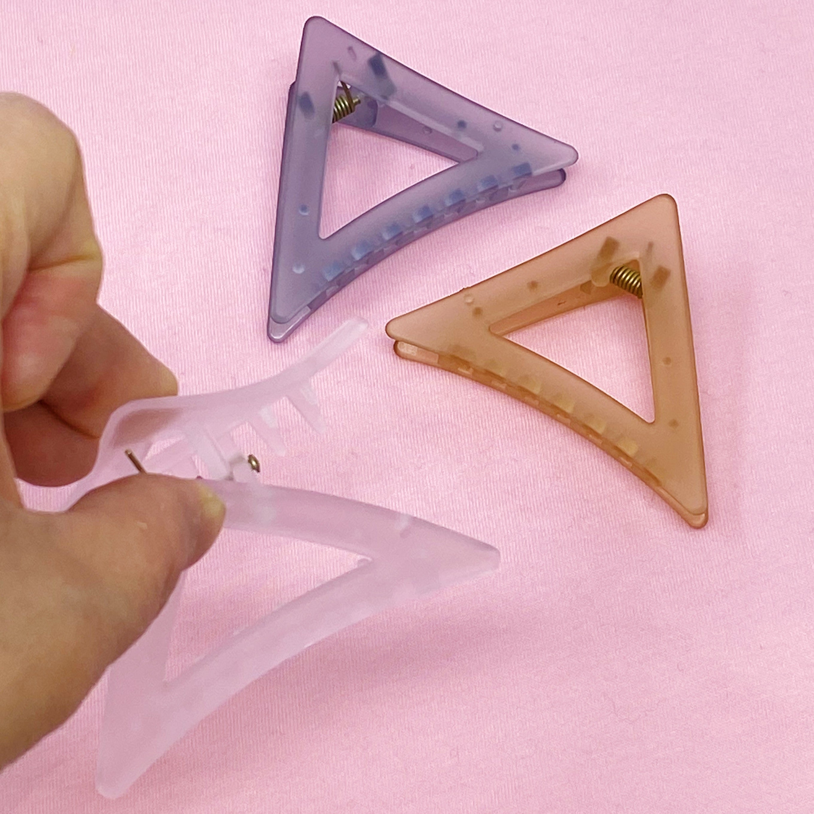 Mistic Splash Hair Claw in triangle shape, sleek acrylic design, perfect for half-up hairstyles.