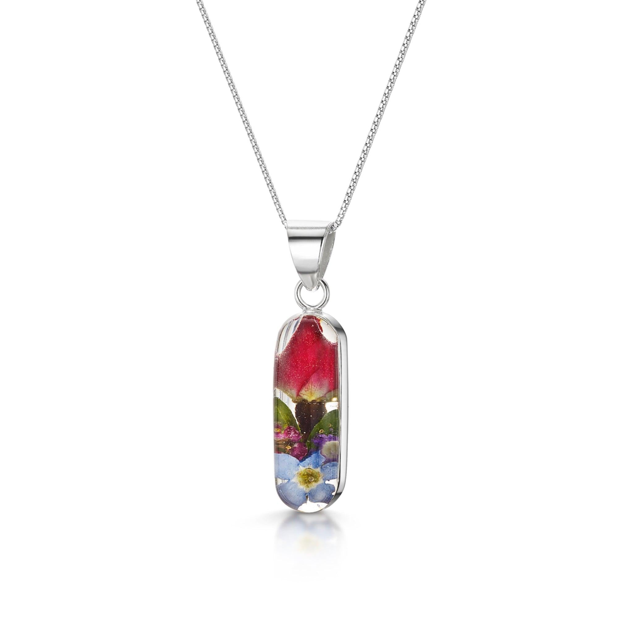 Elegant mixed flower drop earrings 'Leela' featuring miniature roses and vibrant blooms in a sterling silver vertical bar design.