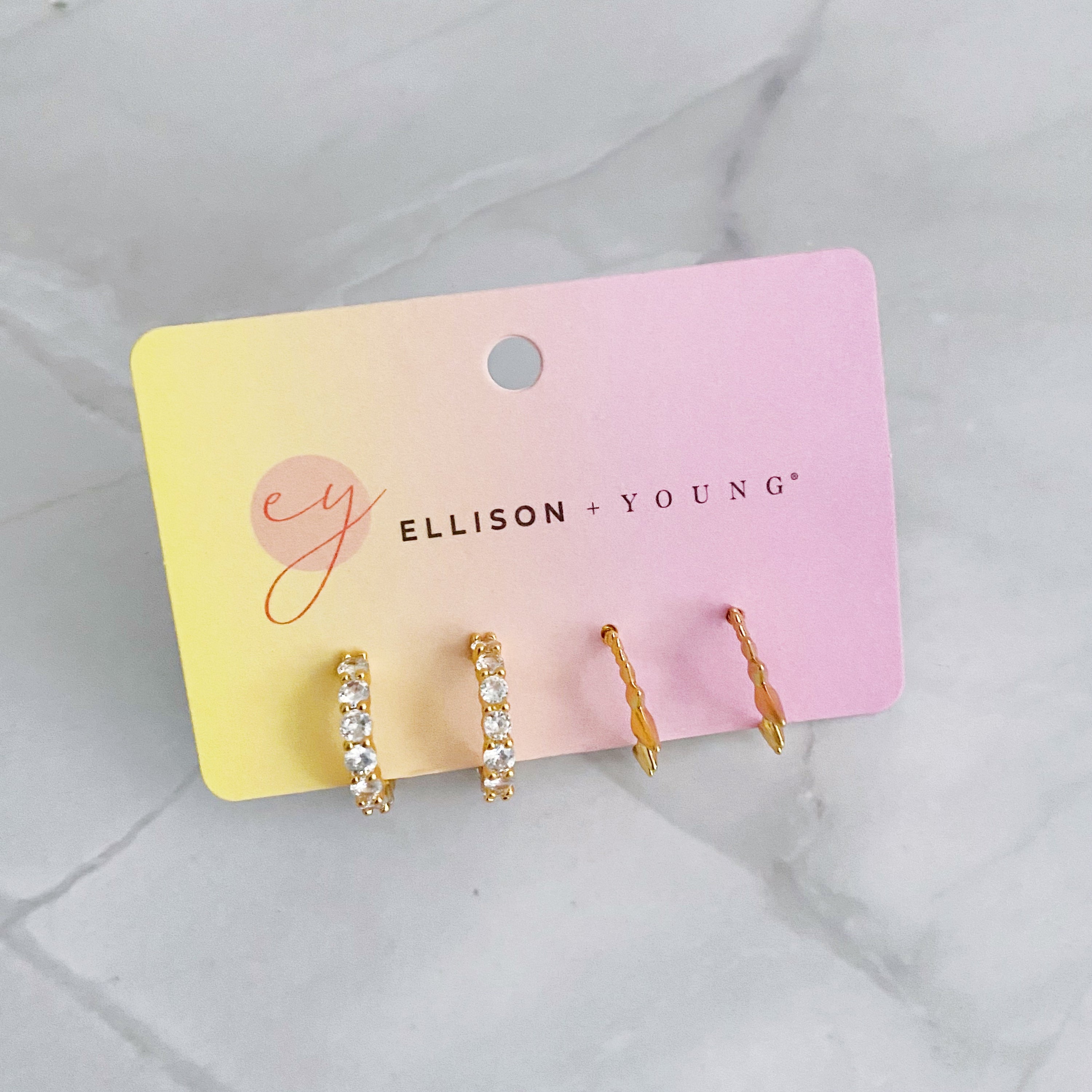 Mood Changer Mini Hoop Earring Set featuring two pairs of earrings, one with sparkly design and the other with edgy spiky details, in 18k gold plating.