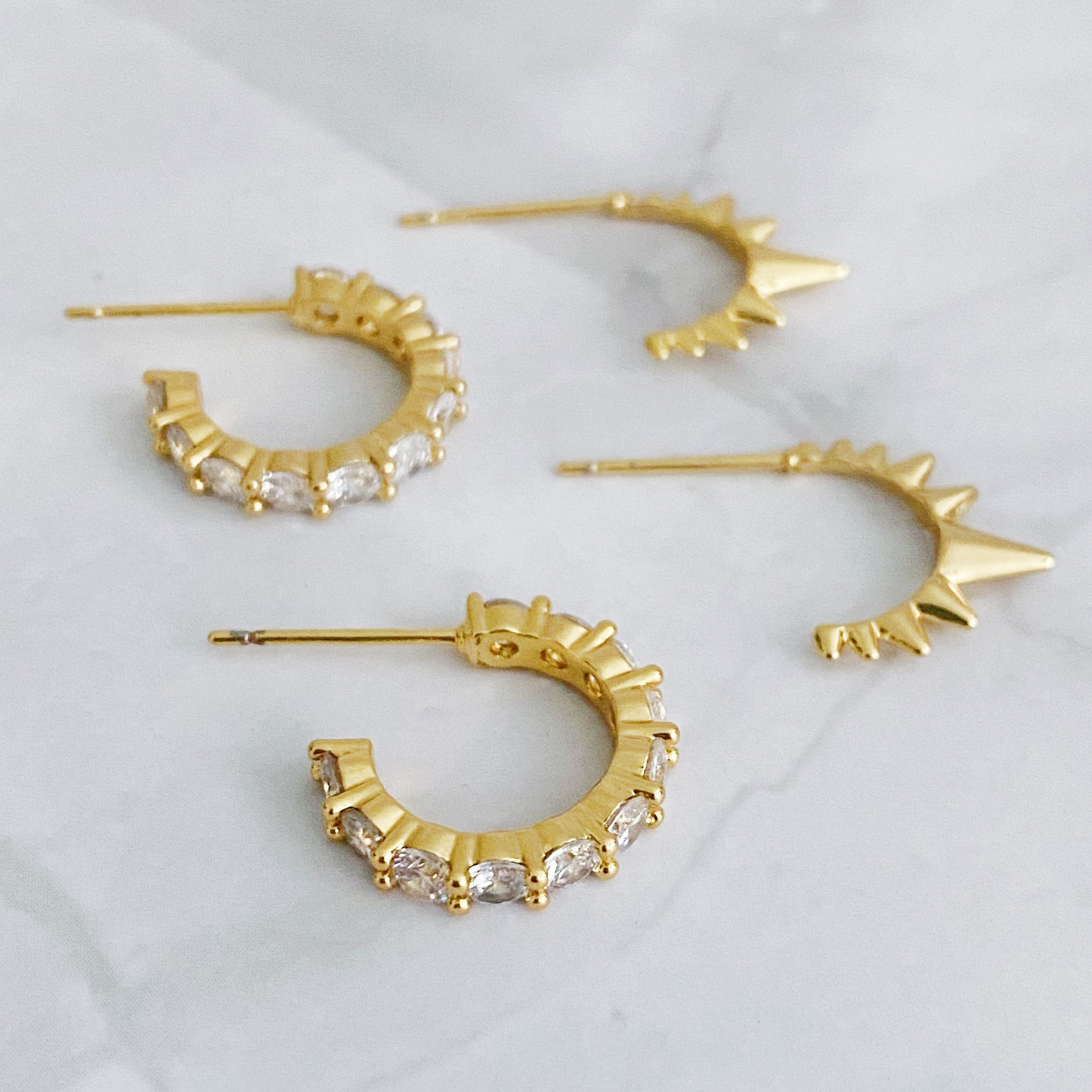 Mood Changer Mini Hoop Earring Set featuring two pairs of earrings, one with sparkly design and the other with edgy spiky details, in 18k gold plating.