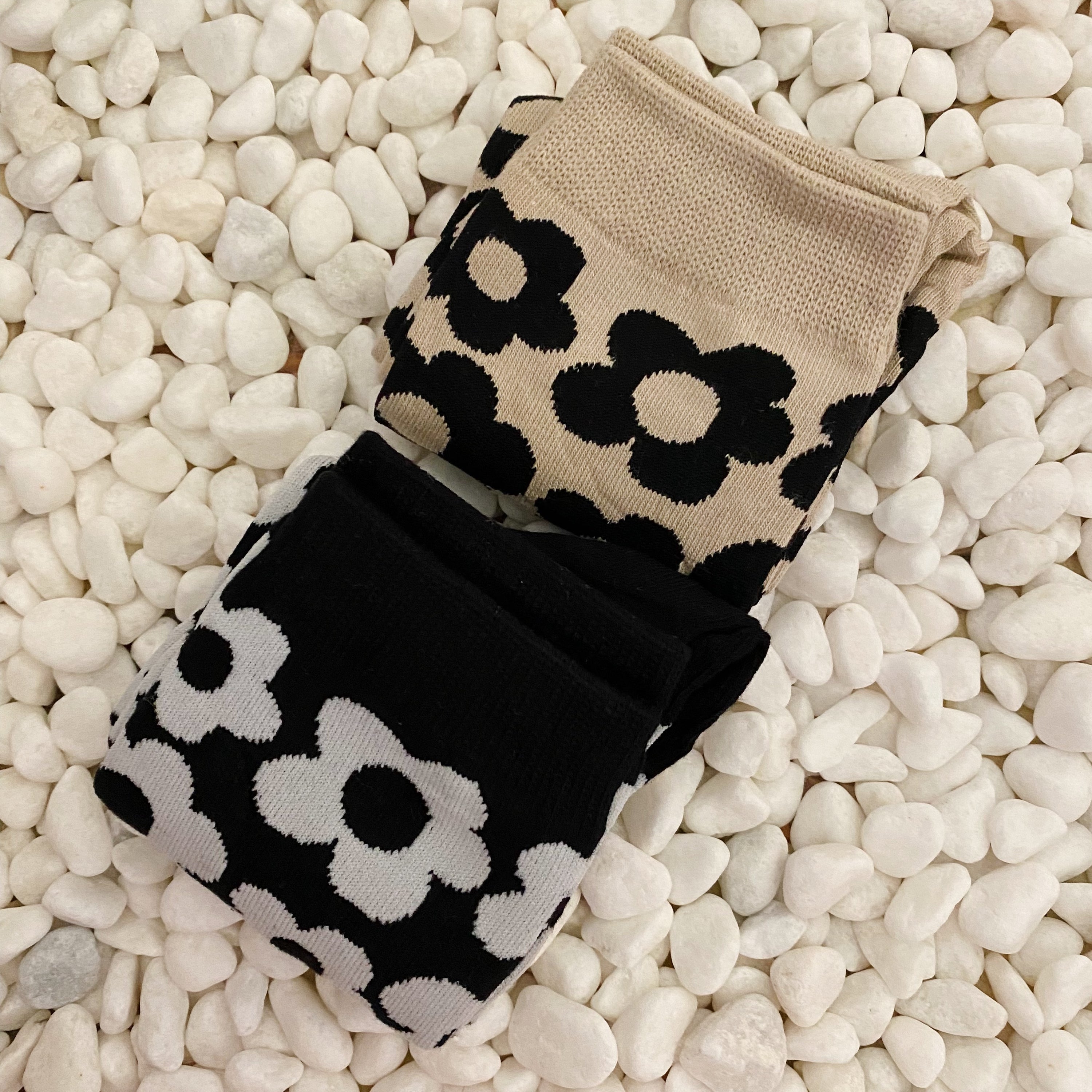 A set of two pairs of modern daisy socks featuring a unique daisy pattern in soft, stretchy material, perfect for comfortable wear.