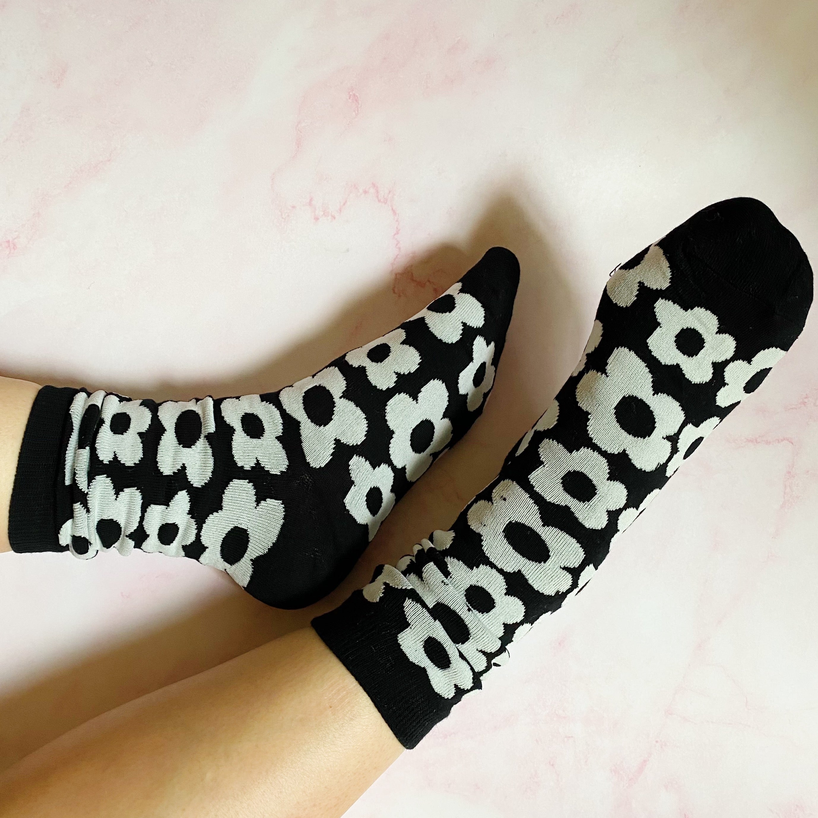 A set of two pairs of modern daisy socks featuring a unique daisy pattern in soft, stretchy material, perfect for comfortable wear.