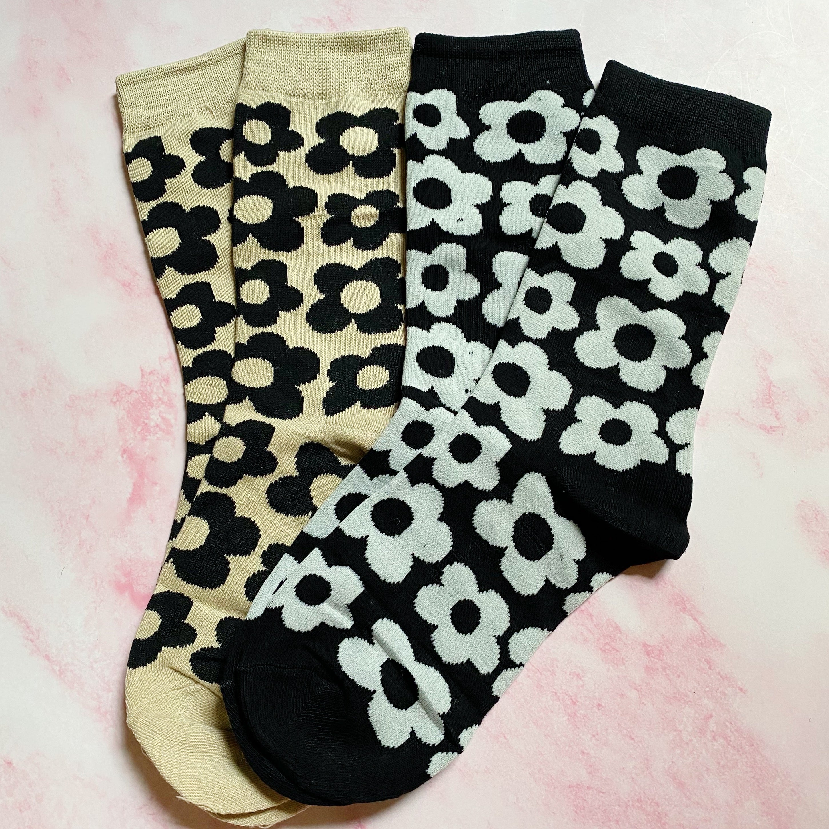 A set of two pairs of modern daisy socks featuring a unique daisy pattern in soft, stretchy material, perfect for comfortable wear.